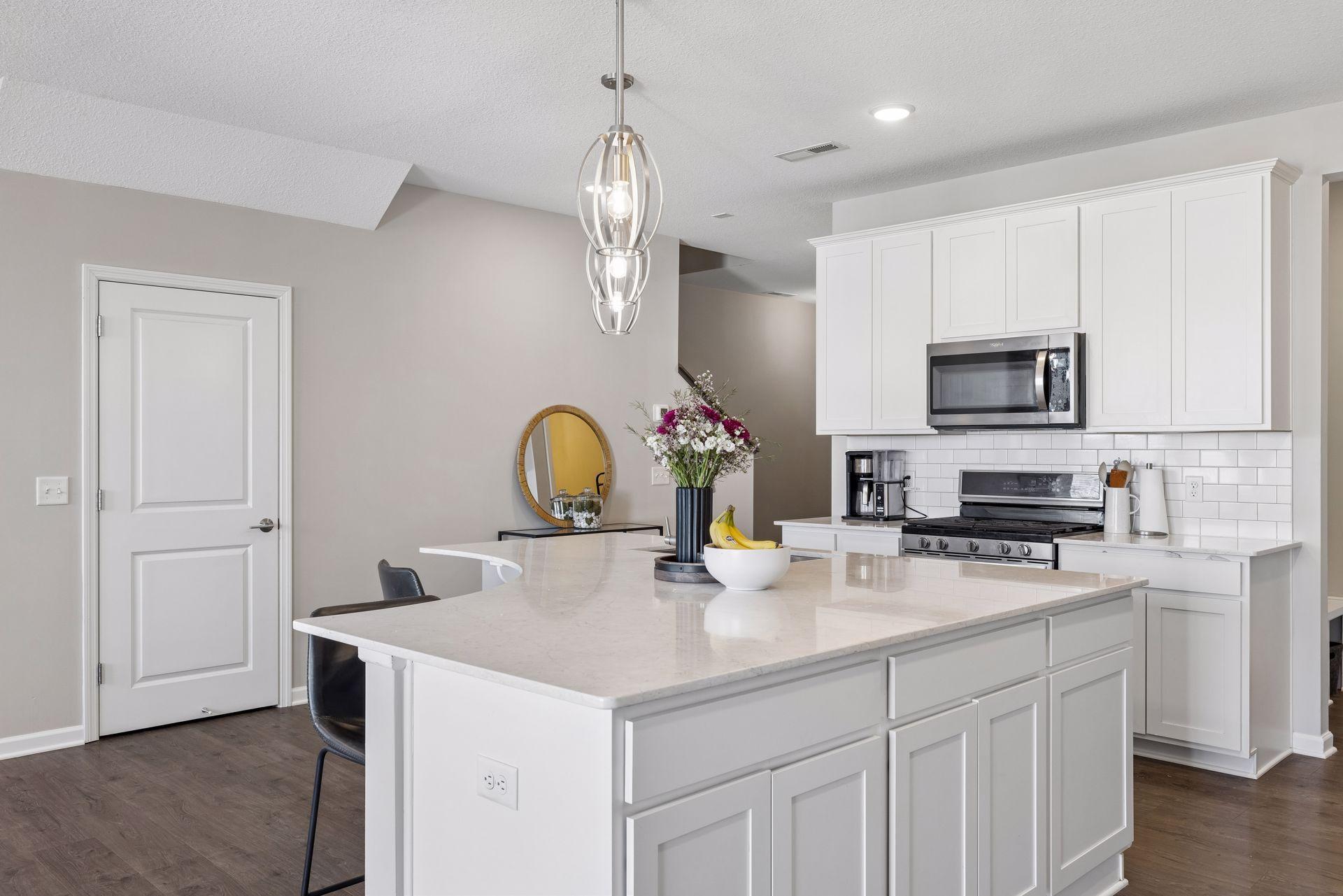 Expansive kitchen island designed for gathering, dining, and added functionality.