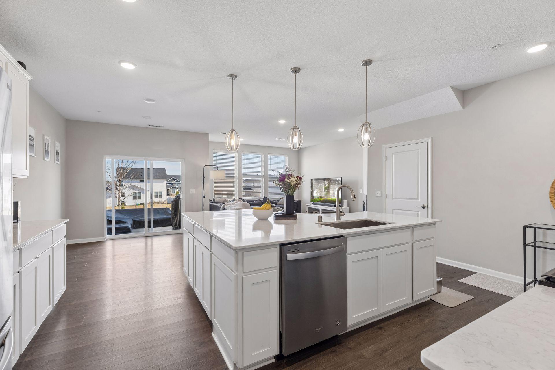 Large kitchen island with built-in dishwasher and sink cutout, ideal for entertaining and daily living.