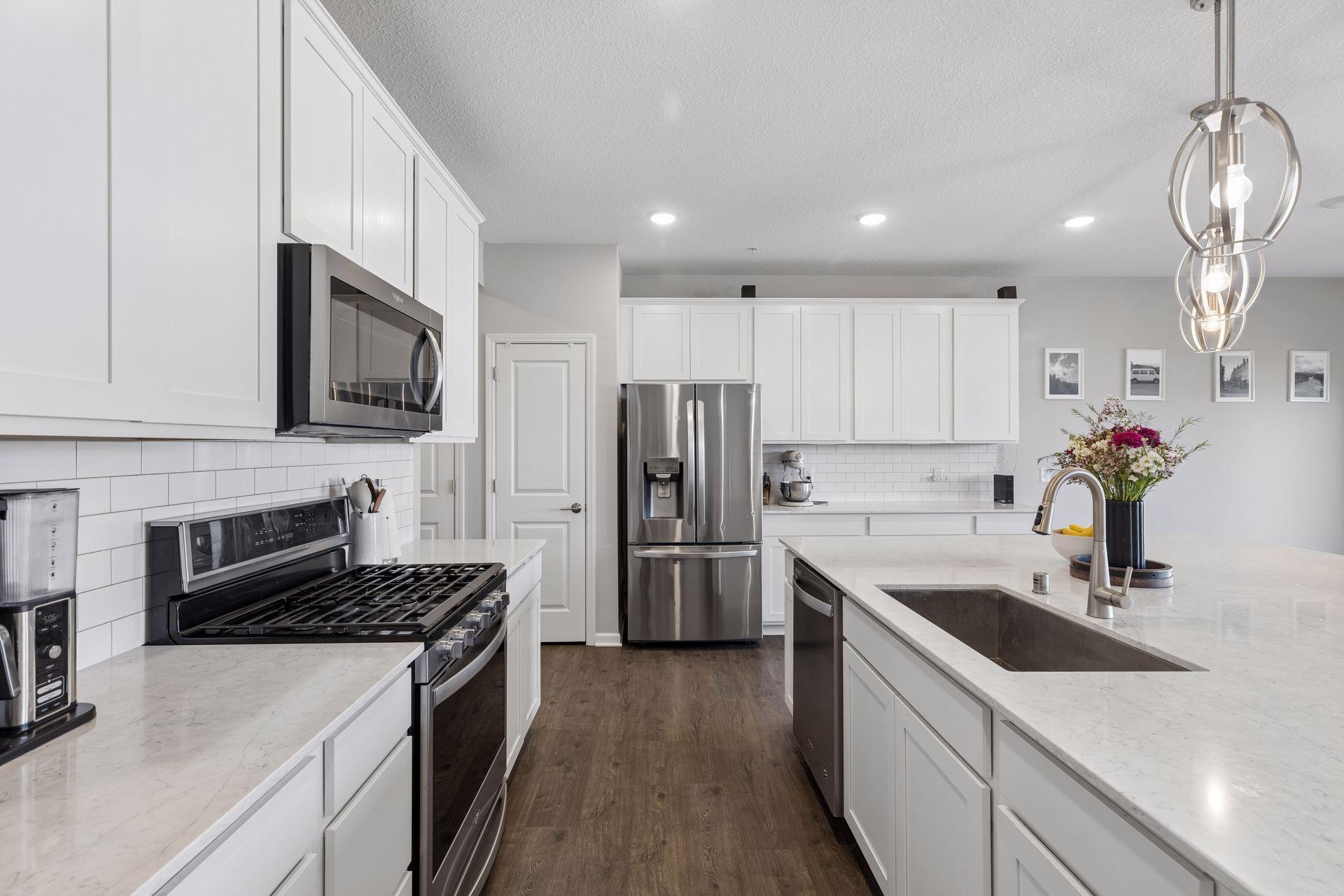 Kitchen walkway featuring stainless steel appliances and efficient layout for everyday use.