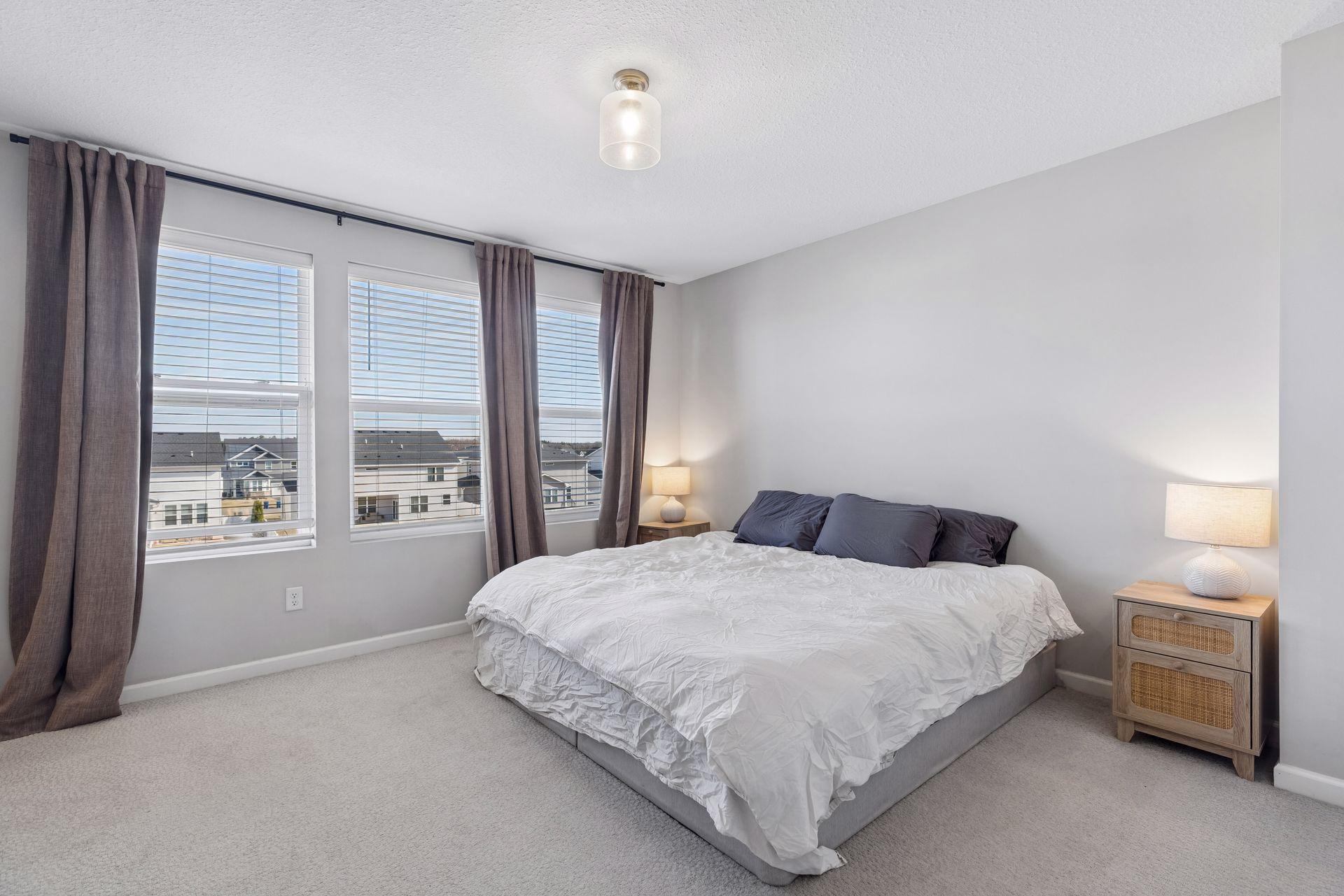 Primary bedroom with large windows and natural light creating a bright and comfortable retreat.