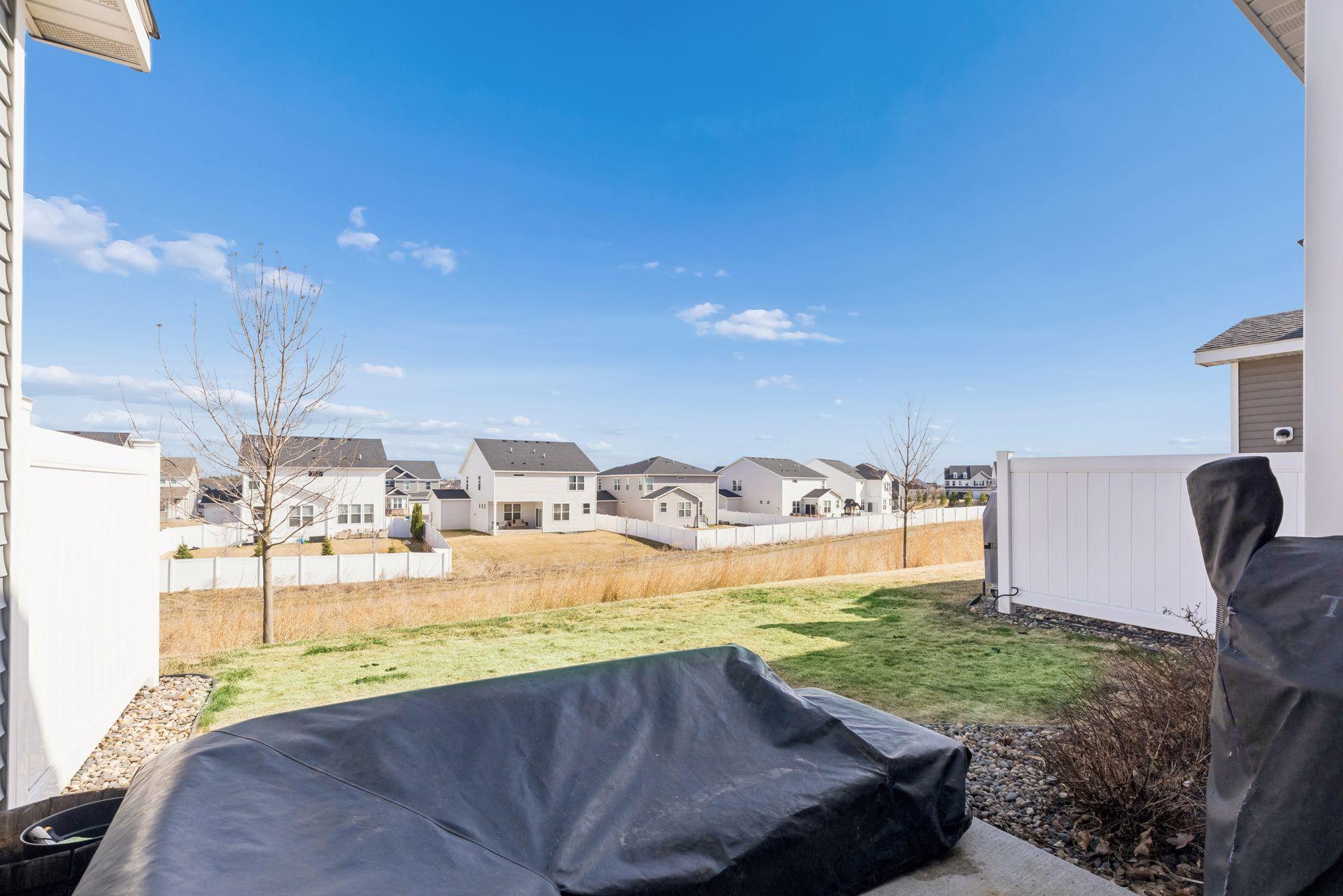 Backyard view overlooking a walking path.