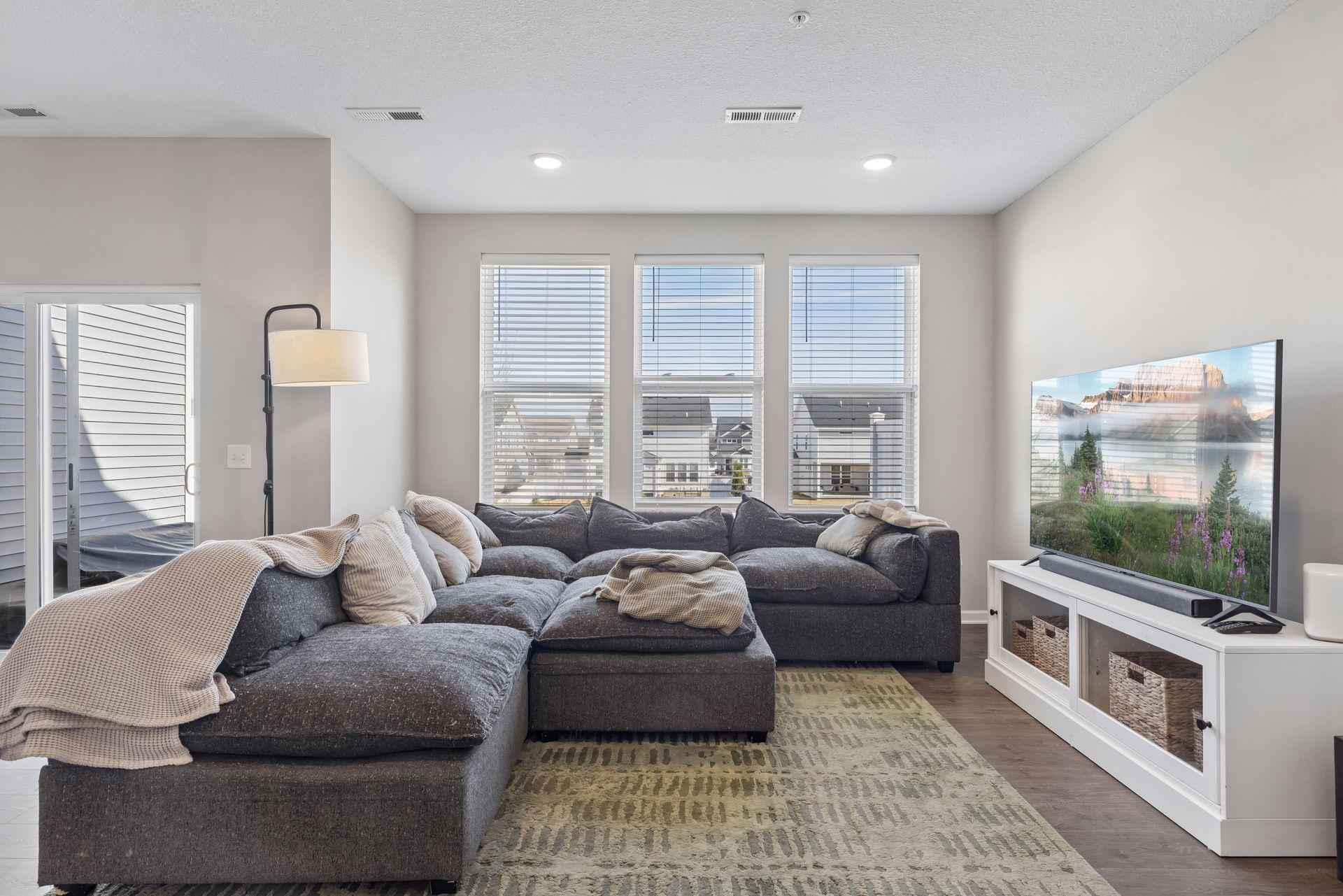 Living room featuring recessed lighting and large windows providing abundant natural light.