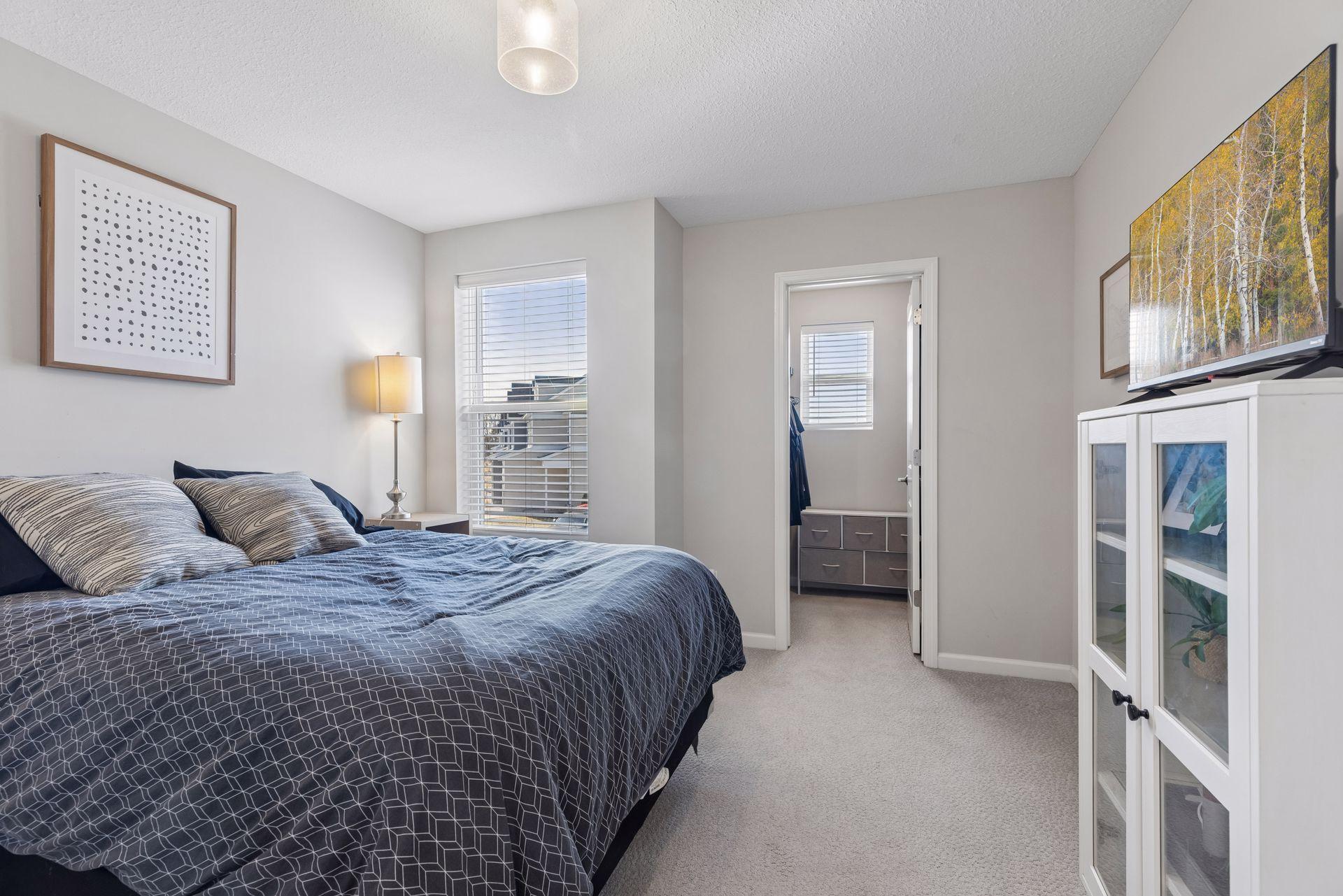 Second upper-level bedroom with versatile space for guests, office, or additional living needs.