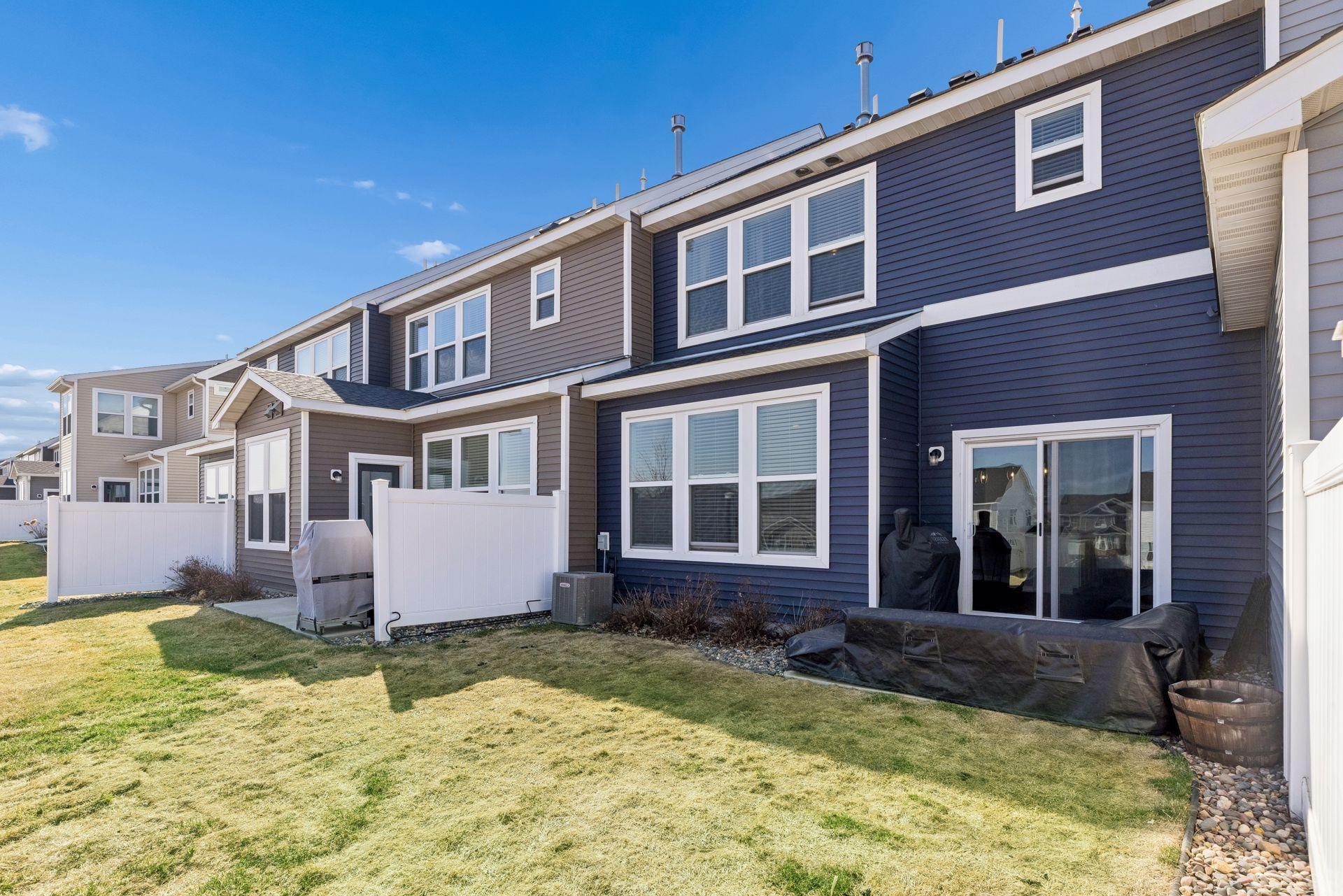 Rear exterior with privacy fencing providing separation from neighboring units.