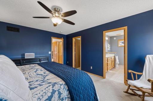 Primary bedroom w/ walk-in closet and private bath
