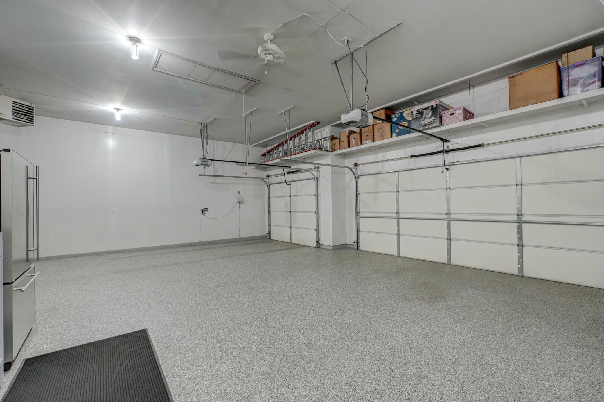 Spacious heated 3-car attached garage featuring updated epoxy floors