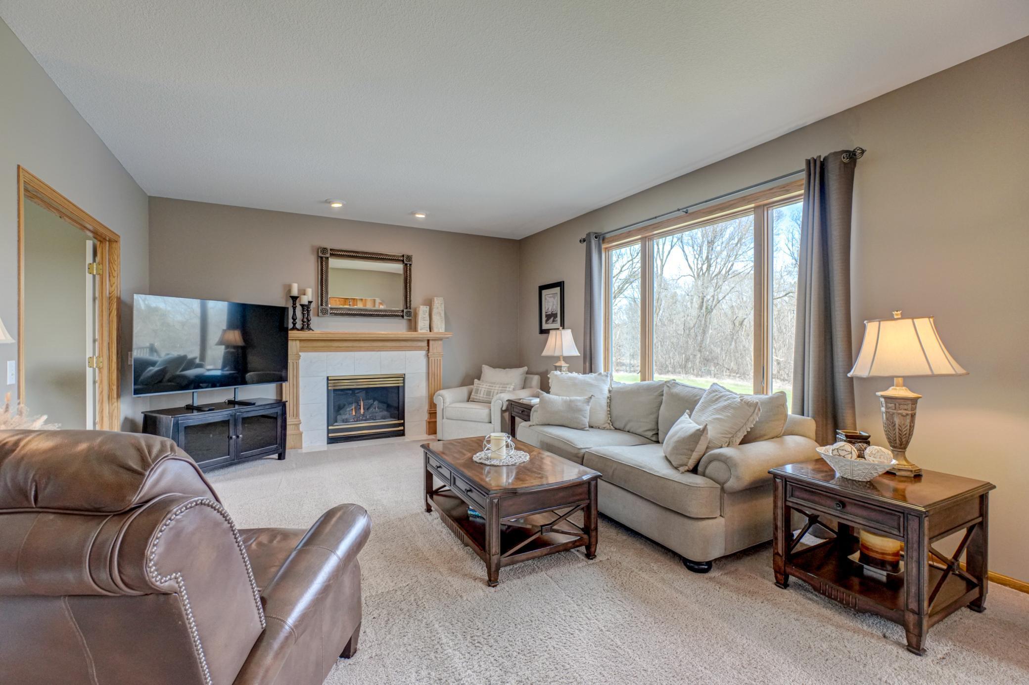 Seamless flow into the main living area anchored by a cozy gas fireplace