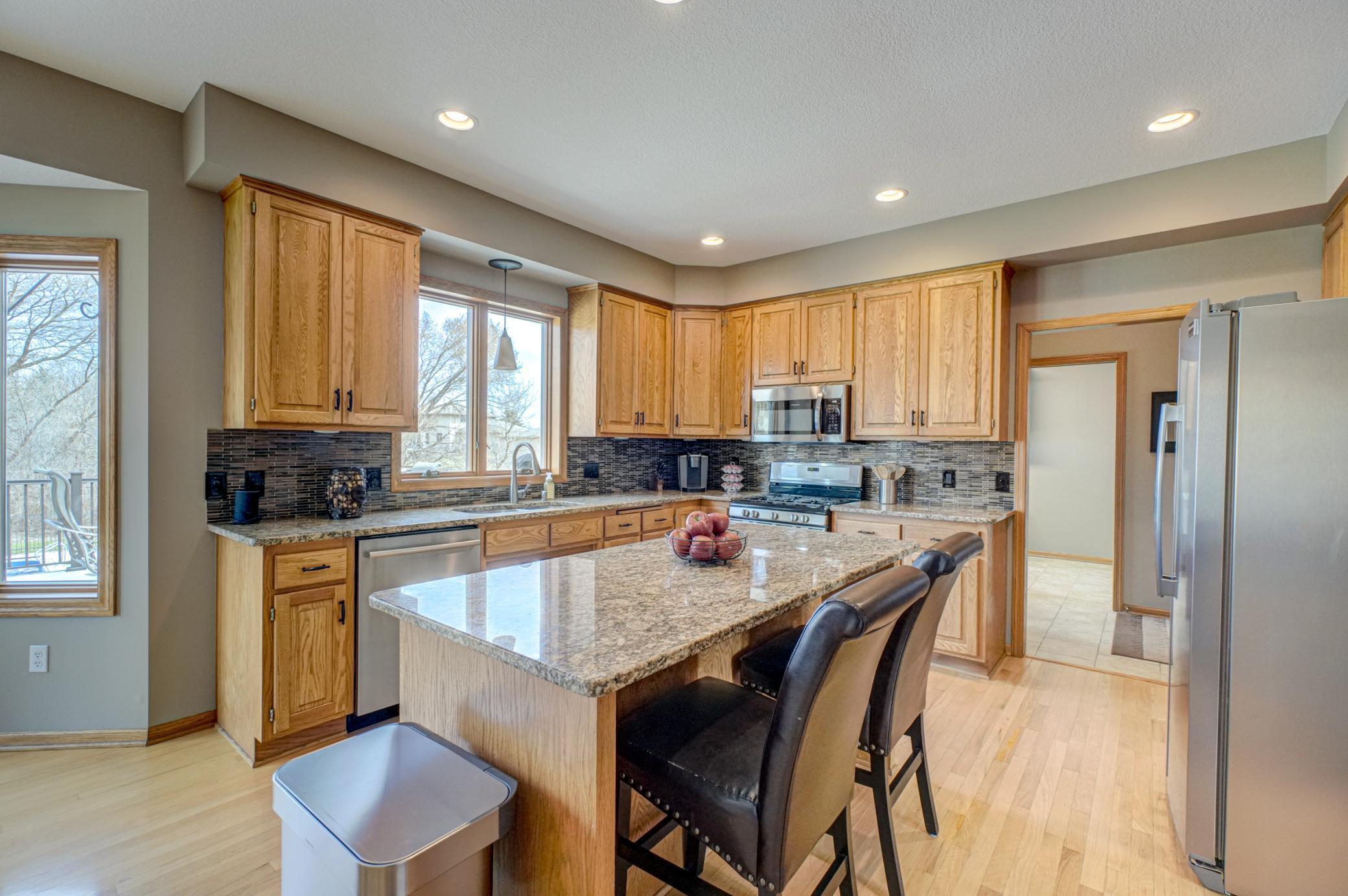 Beautifully updated kitchen showcasing granite countertops, stainless steel appliances, and a stylish tile backsplash!