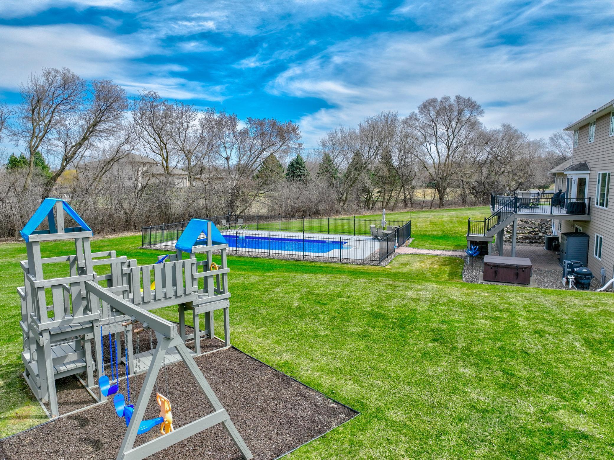 Ultimate backyard for all ages featuring a heated pool, hot tub, and playground