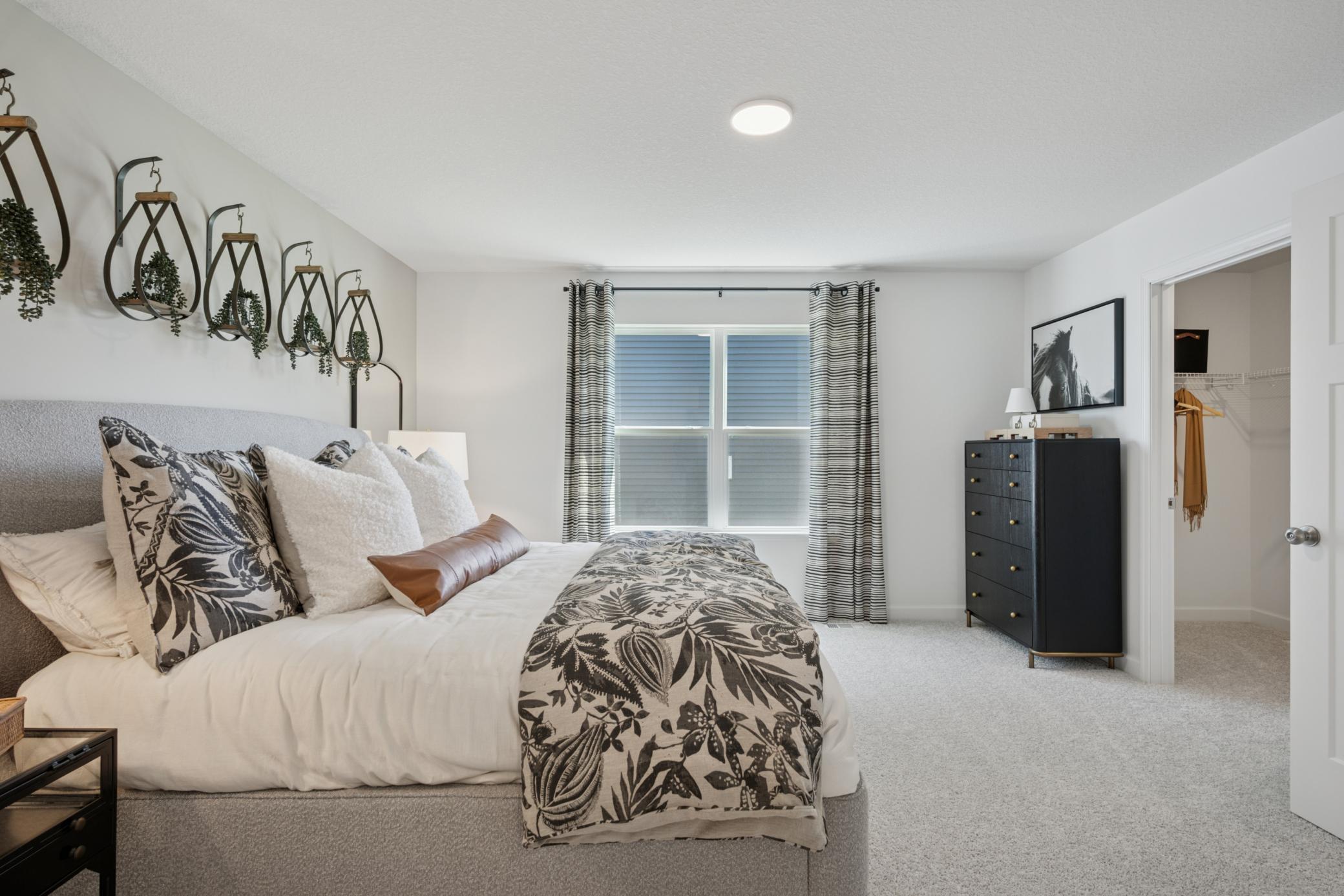 (Photo of a model home, finishes will vary) Rest and relaxation await in the owner’s suite, which is situated on the upper level and features a tranquil bedroom, a spa-inspired bathroom and a walk-in closet.