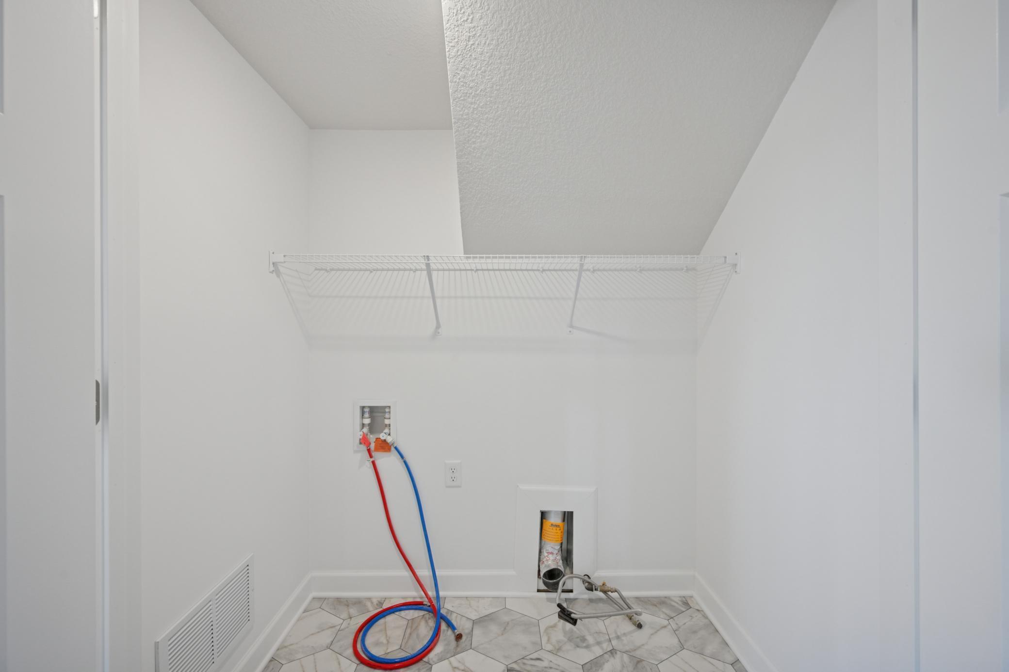 (Photo of a model home, finishes will vary) The laundry room.