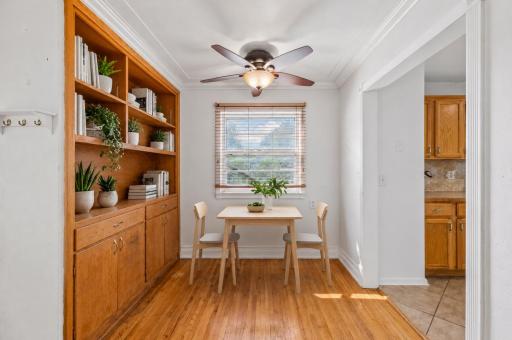 Enjoy meals in this light-filled dining area featuring timeless built-in cabinetry and hardwood floors. **Virtually staged to show design options.**