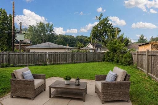 The concrete patio and private backyard provide the perfect setting for grilling, gathering, or unwinding. **Virtually staged to show design options.**