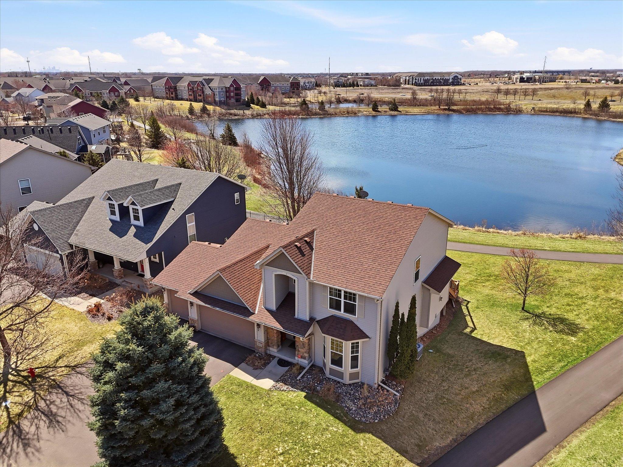 Aerial view from front with pond and trails