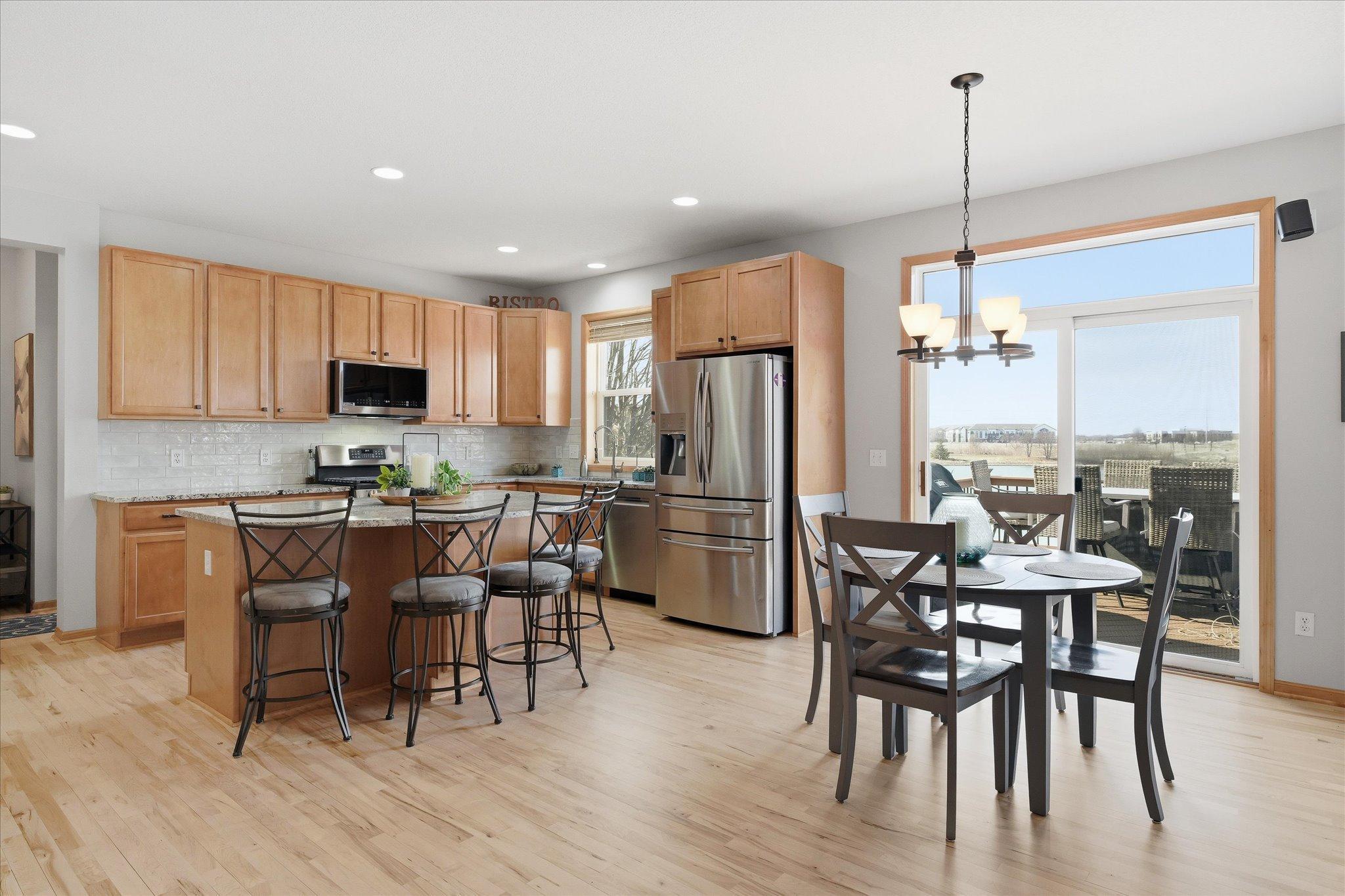 Open main floor Kitchen and Dining Rooms with refinished maple hardwood floors