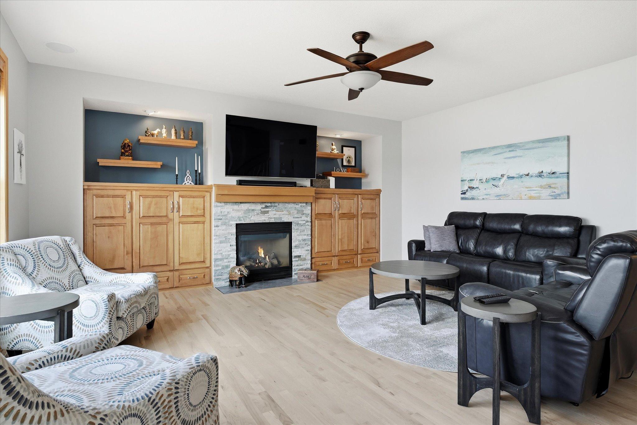 Enjoy cozy gas fireplace and custom maple built-in cabinets and floating shelves in your open Family Room