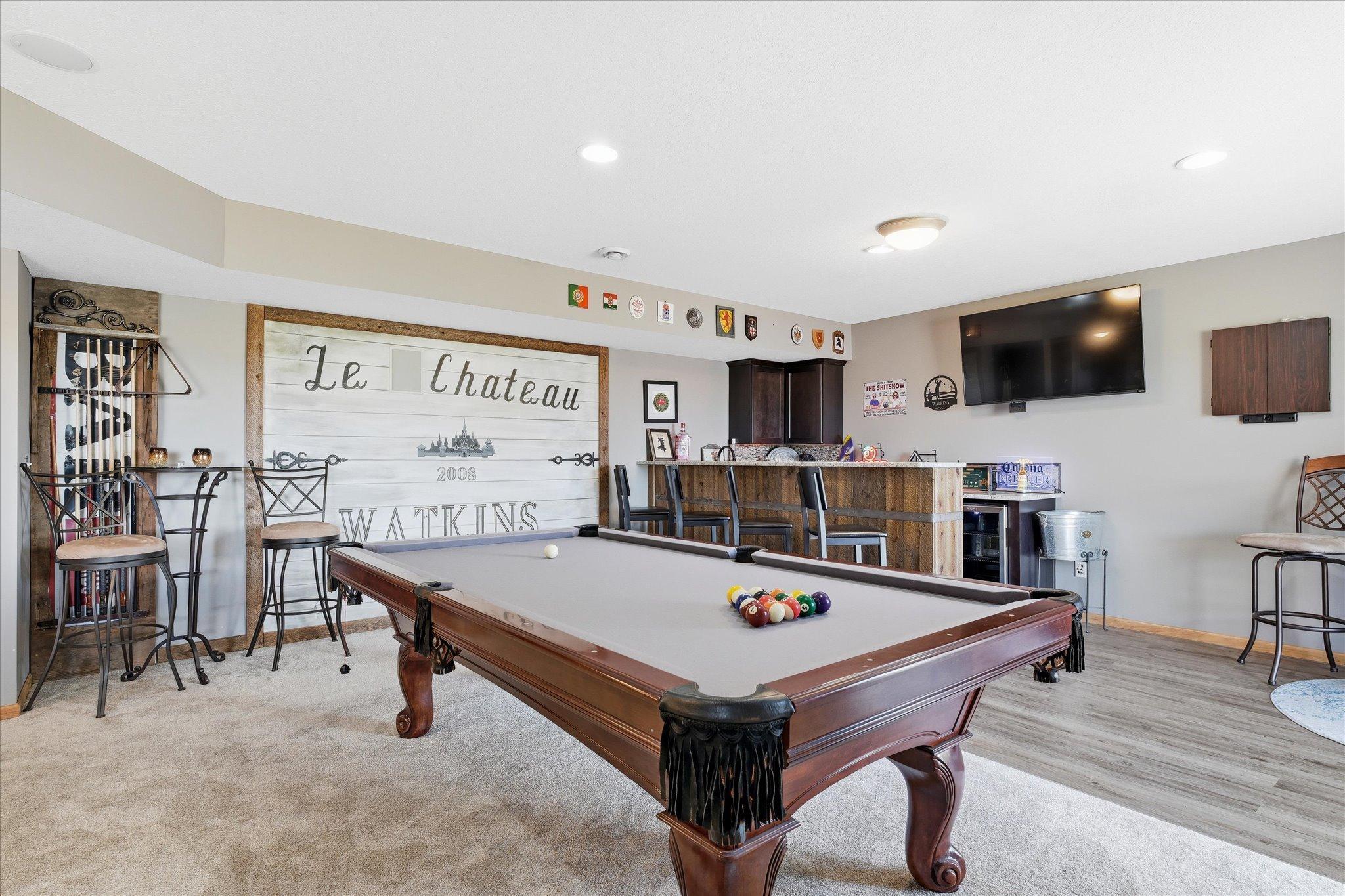 Lower Level Amusement room features custom wet bar area, recessed lights and walkout to patio area
