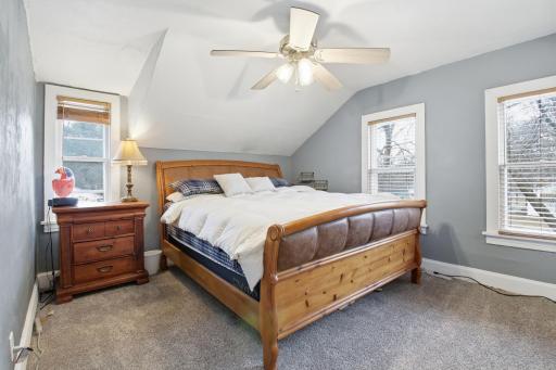 Upper level primary bedroom. Lots of windows and fan for peace and comfort.