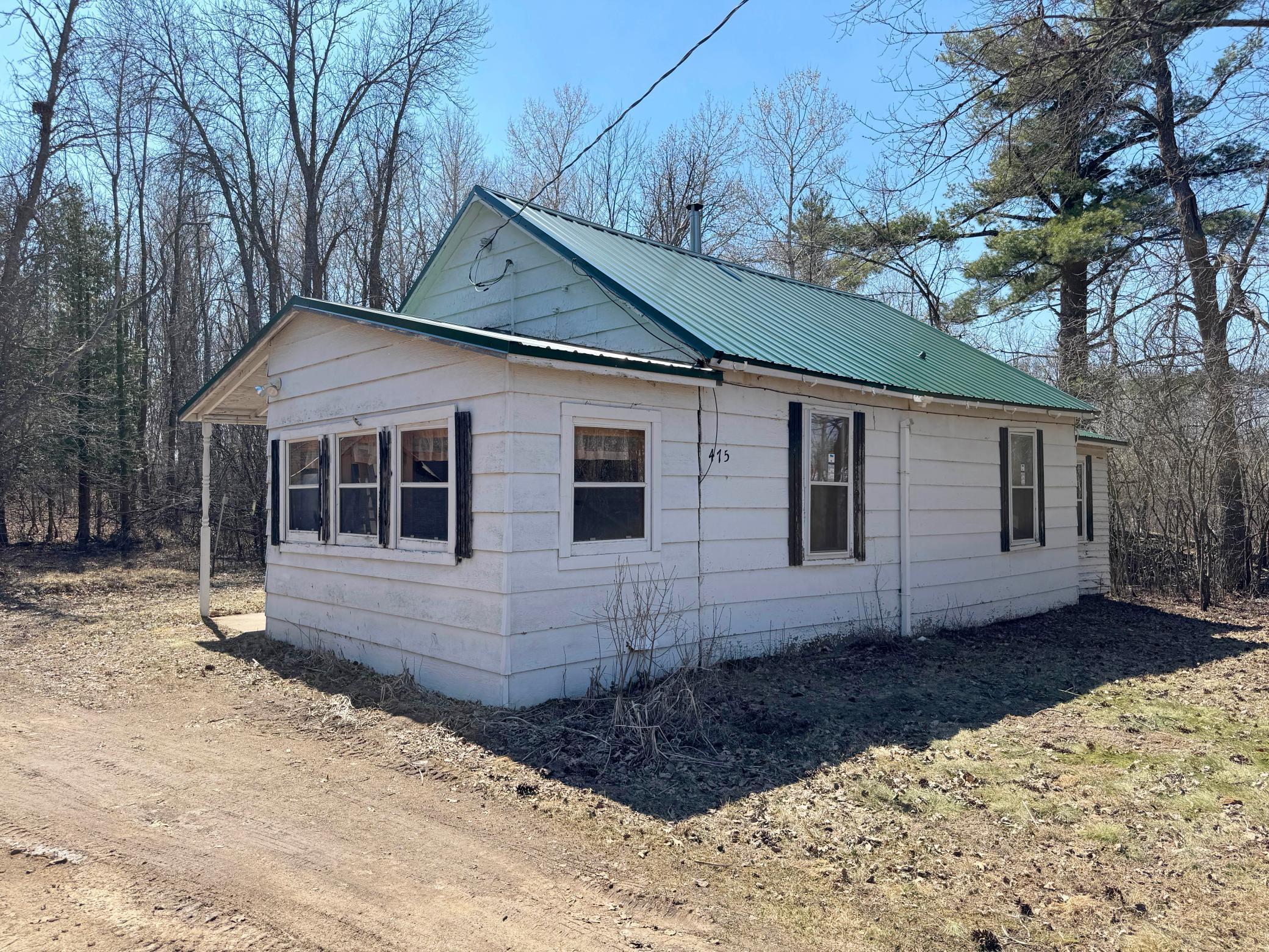 An amazing 2+acre lot in city limits of Isle! Fix up and use this year-round home for now and consider your future plans for this spacious lot down the road! Here is a shot of the house's exterior from the long driveway in.