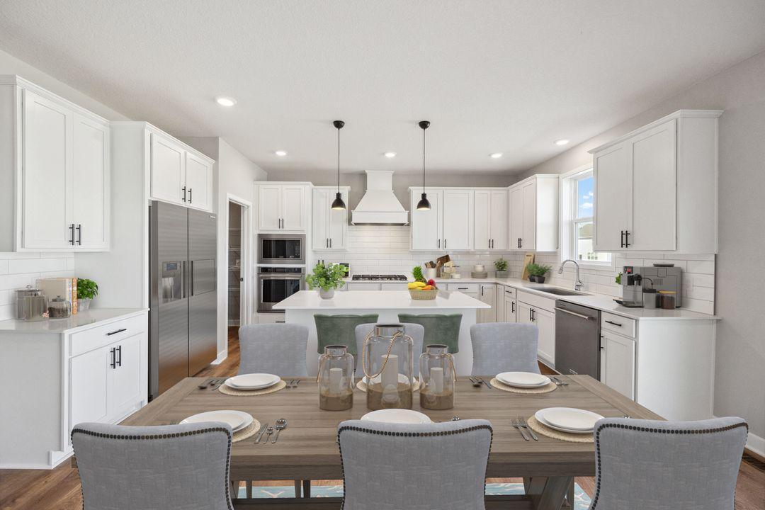 Kitchen connects to this informal dining space, right next to the sliding door to the backyard. Model photo, options and colors may vary.