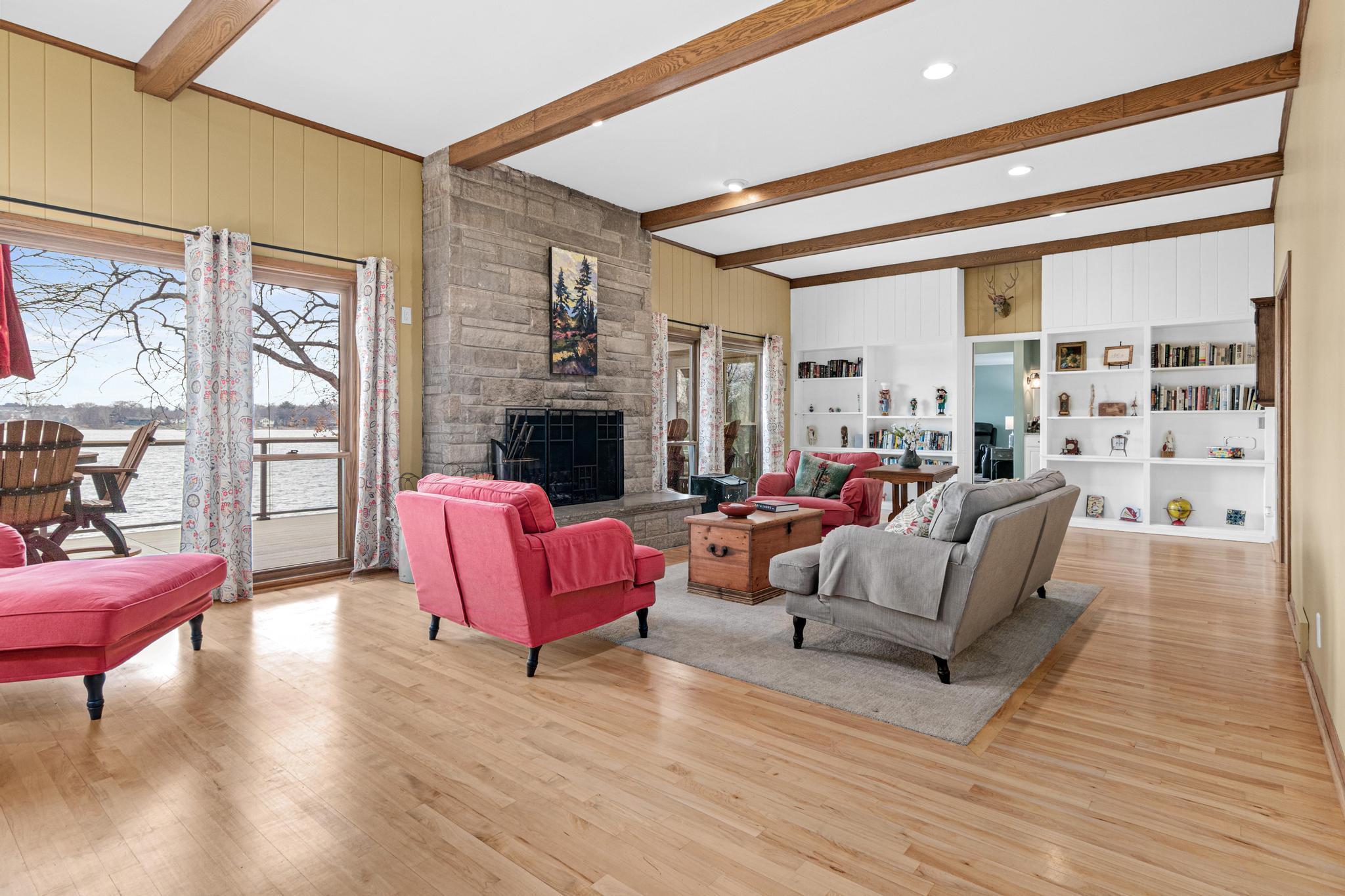 Living room with fpl overlooking lake