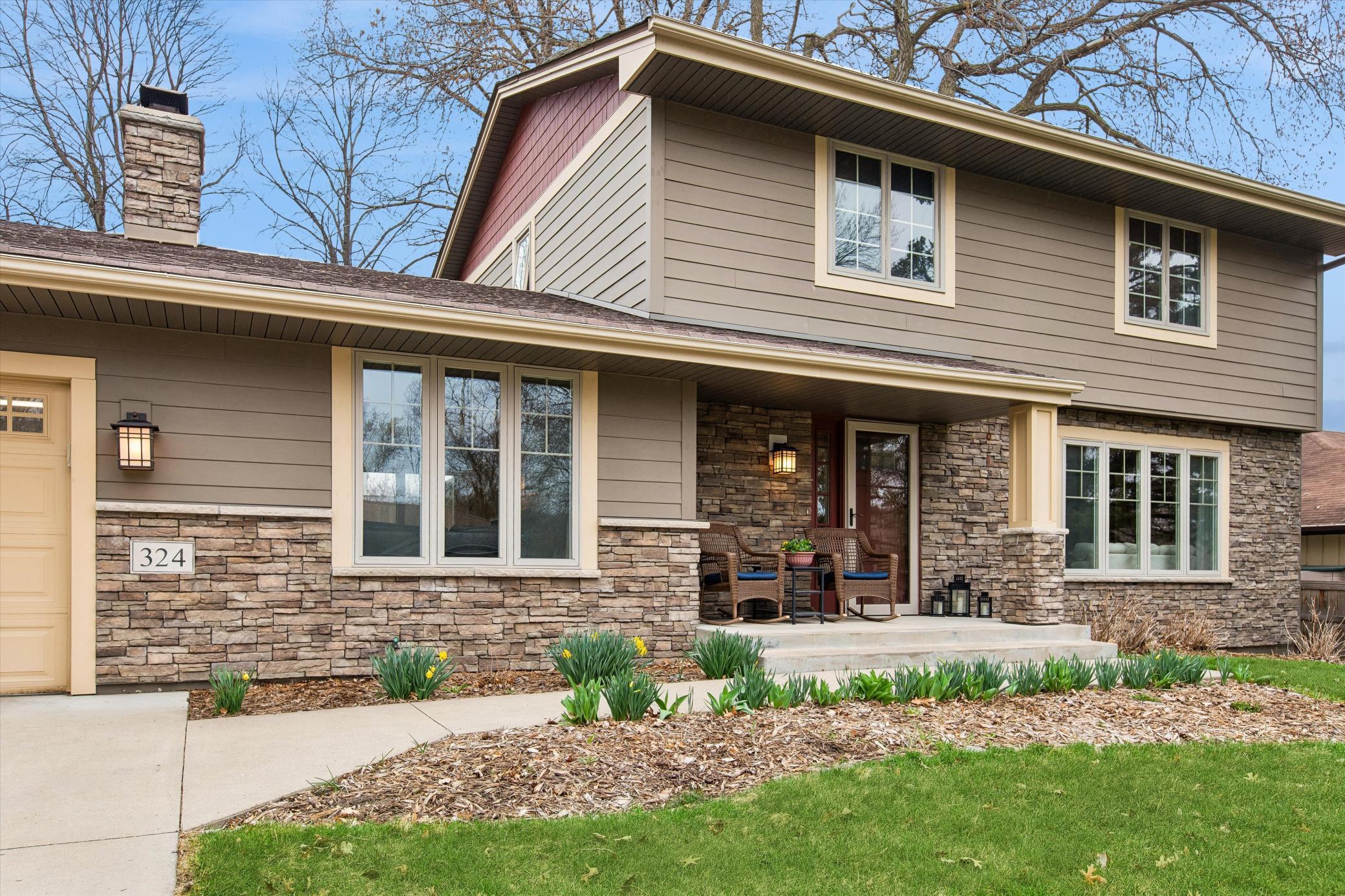 Concrete Stoop & Covered Front Porch. Gorgeous perennial plantings.