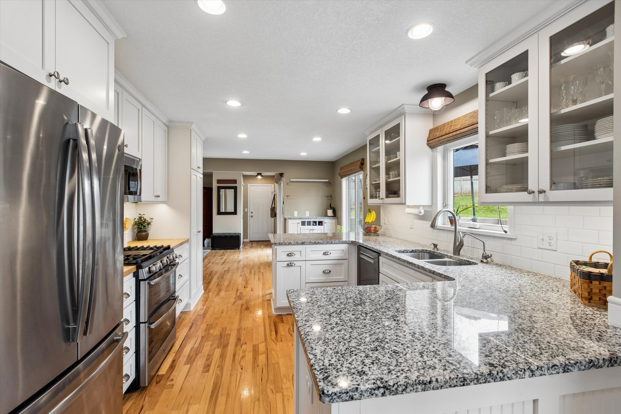 Updated kitchen with granite countertops and subway tile backsplash.