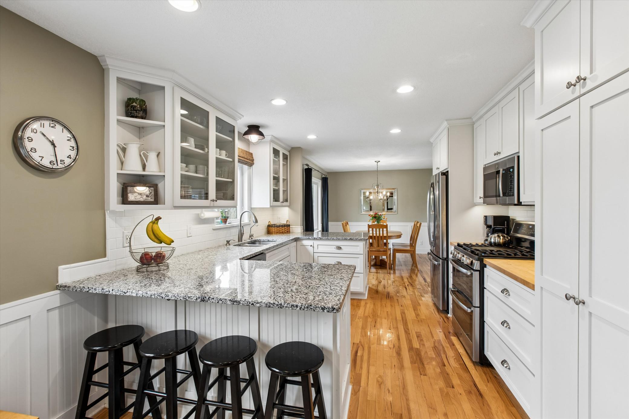 Kitchen with convenient snack bar and pantry.