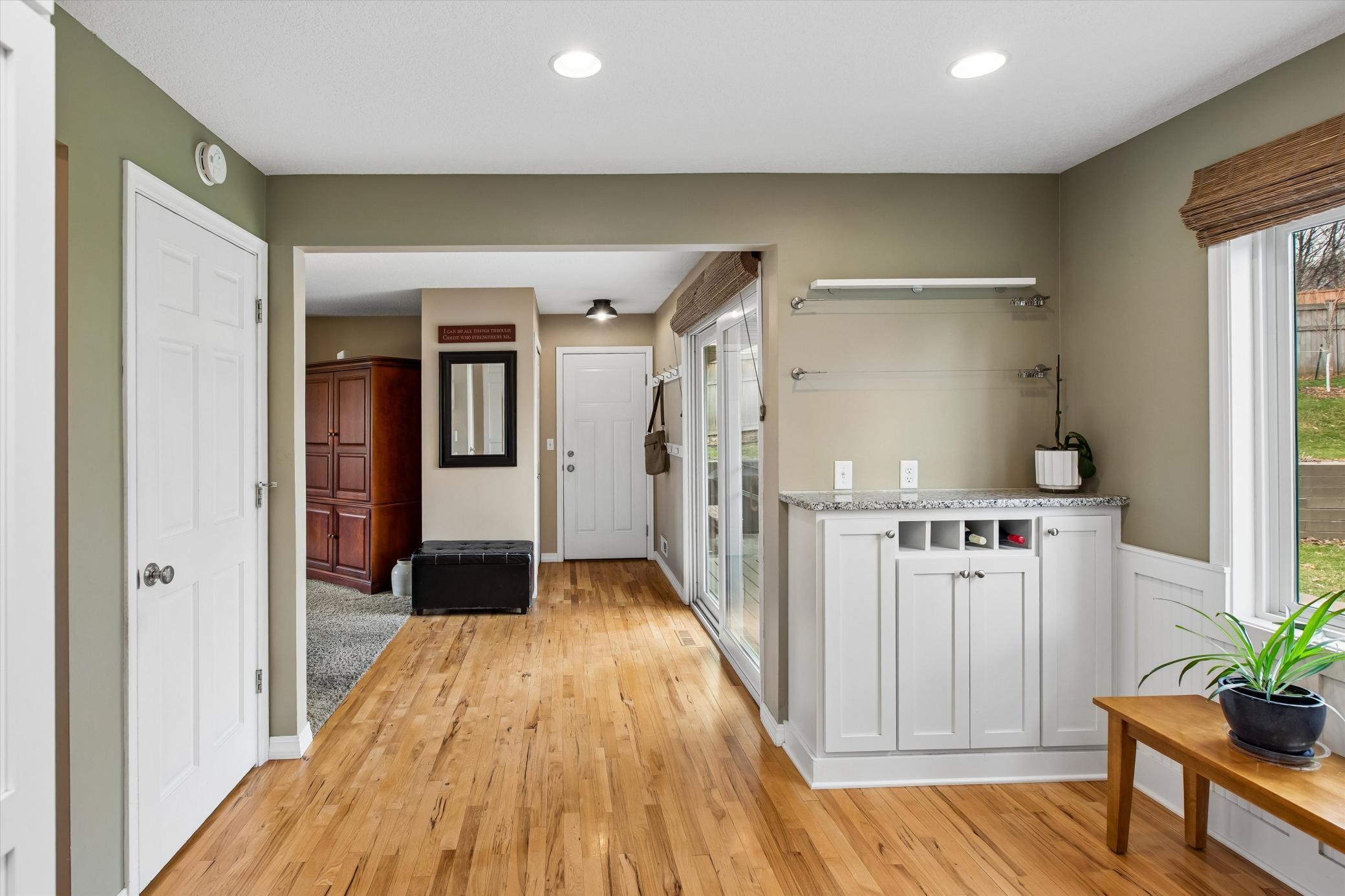 View to the door to the patio door to backyard and to the garage. Includes a closet space. Hickory Hardwood flooring throughout. Notice the drop counter.