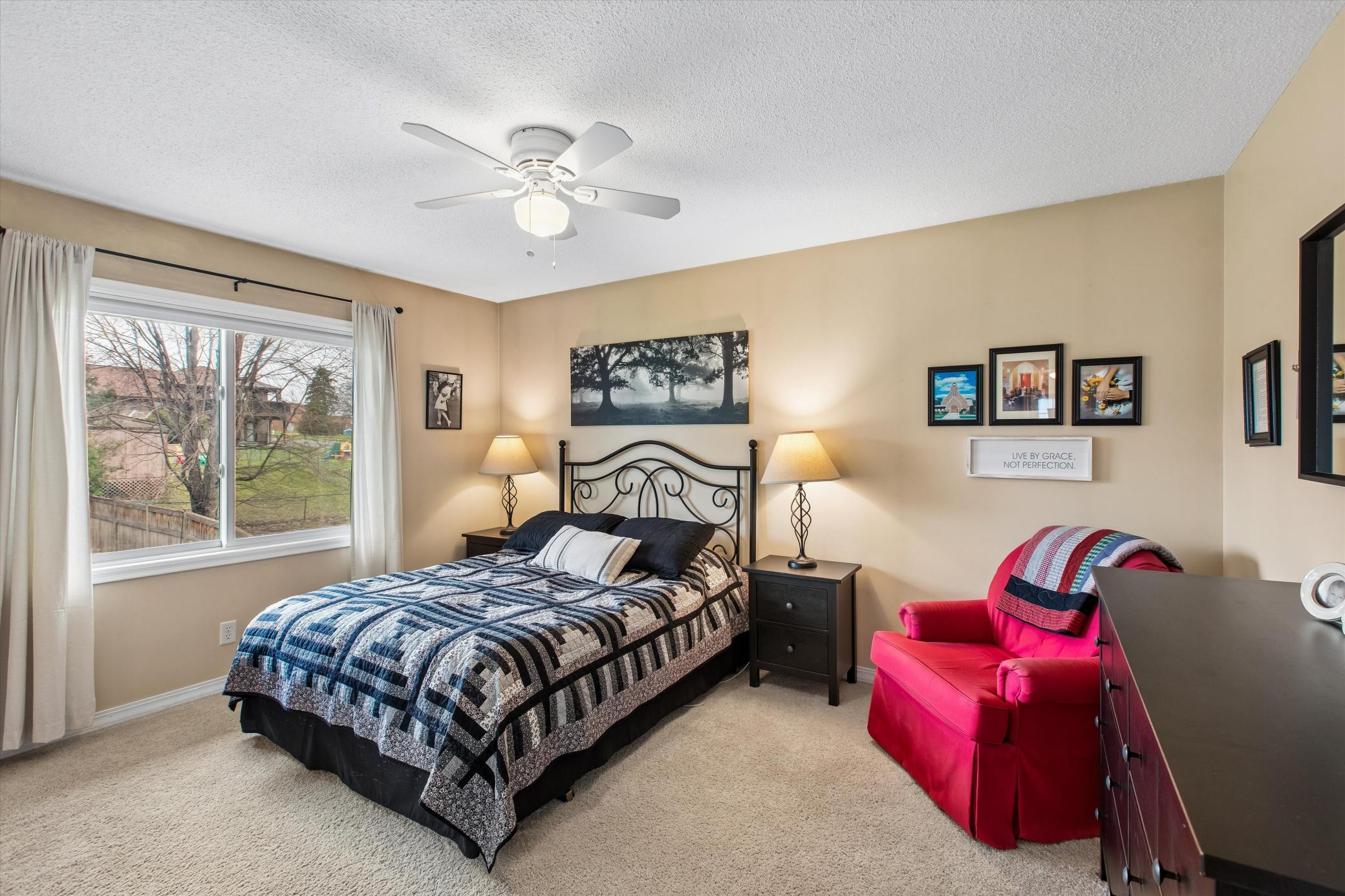 Primary Bedroom. Ceiling fan and carpet.