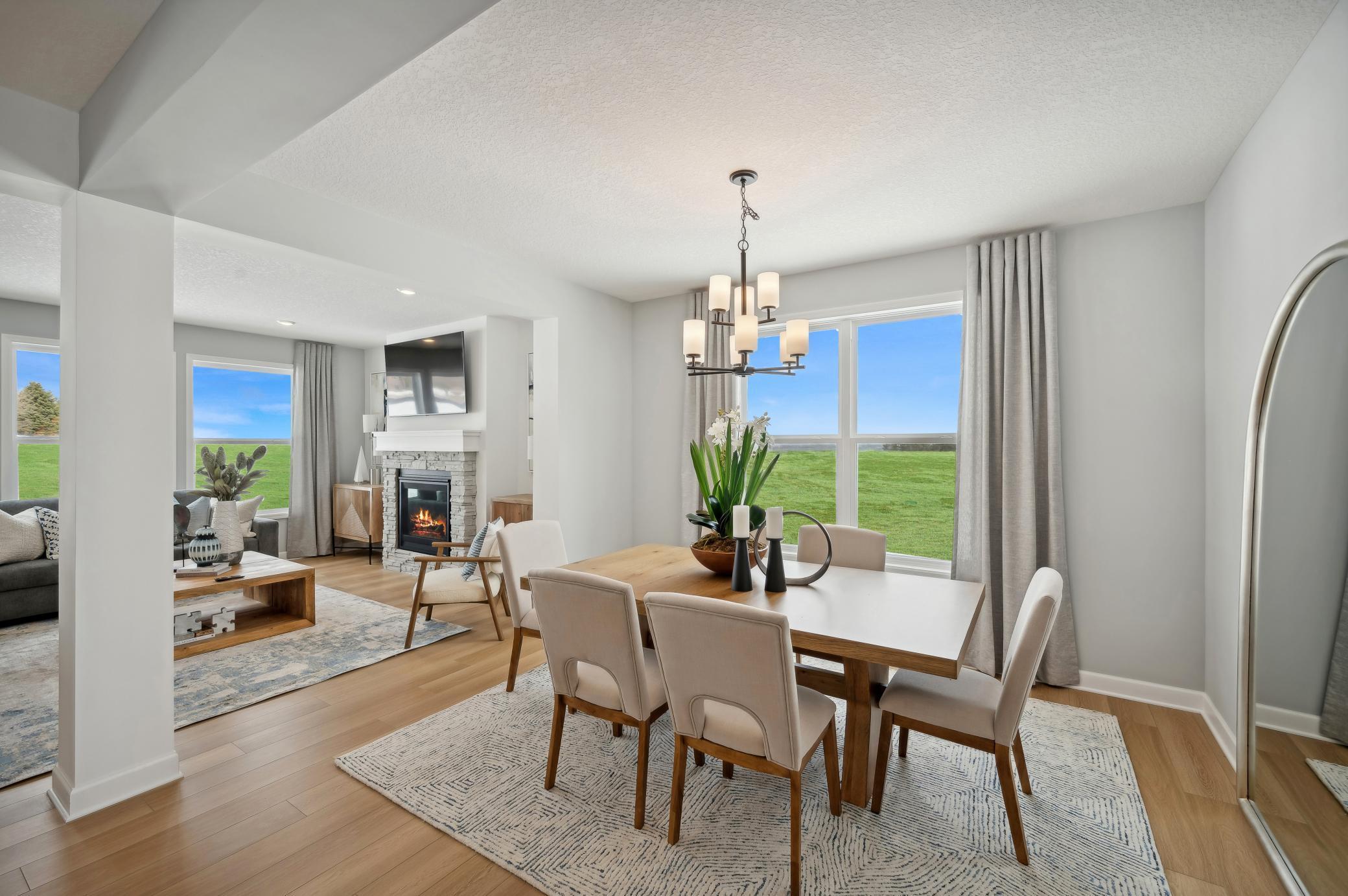 (Photo of a decorated model, actual homes finishes will vary) This formal dining area is large enough to comfortably accommodate a 10-seat dining room table.