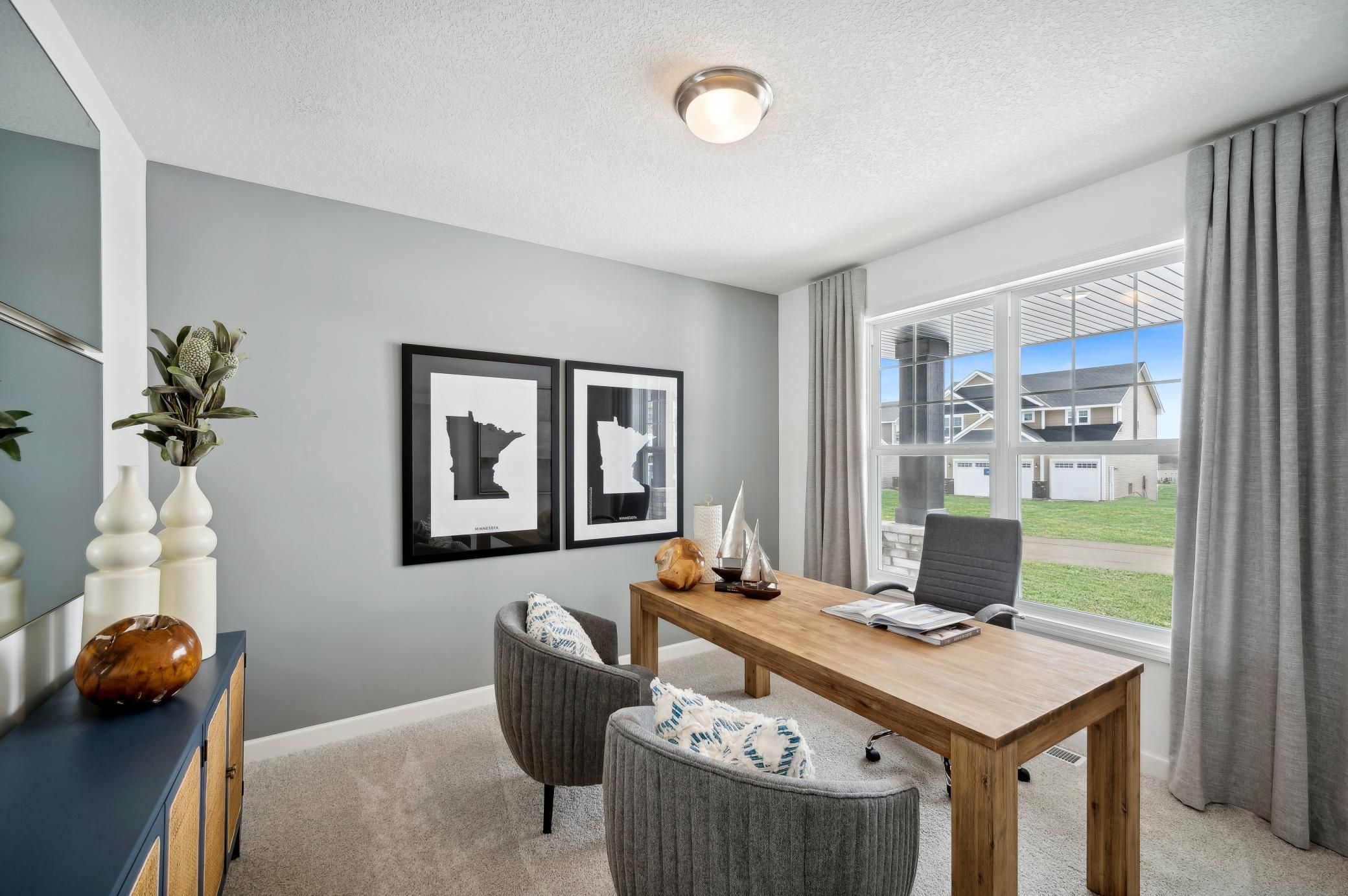 (Photo of a decorated model, actual homes finishes will vary) This main level study provides a perfect setting for those working from home, paying bills or completing a school project.