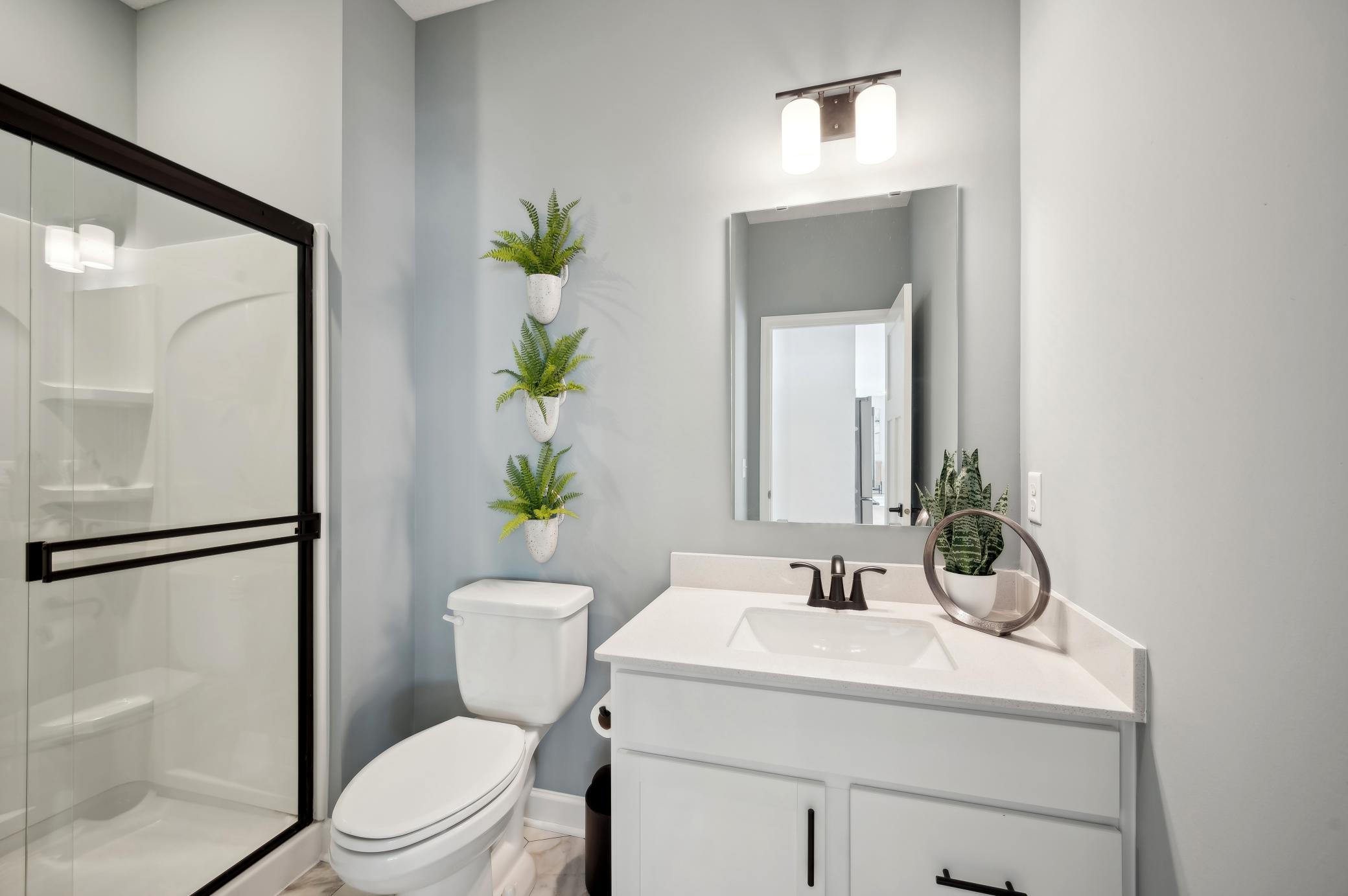 (Photo of a decorated model, actual homes finishes will vary) The main level bath.
