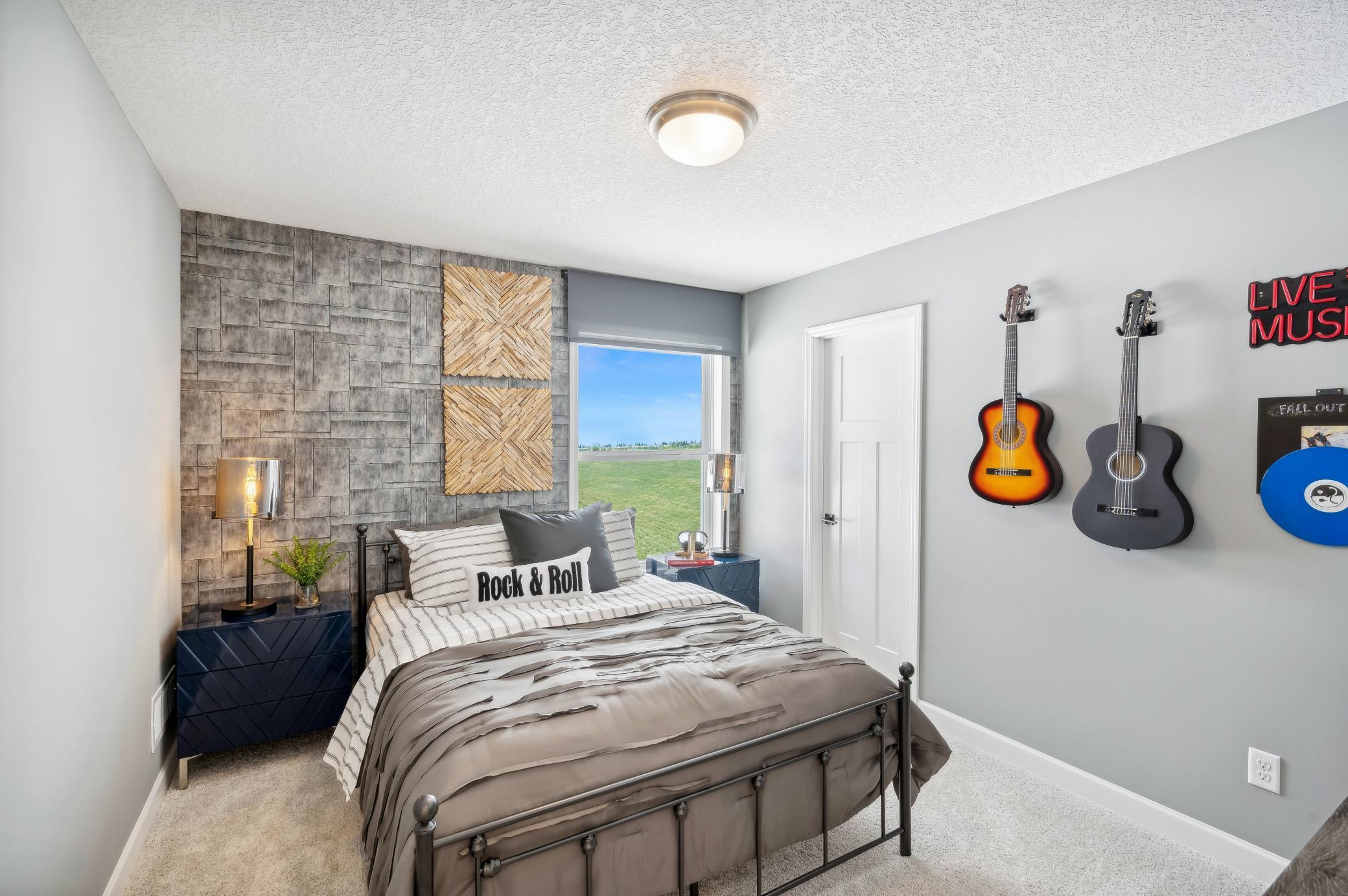 (Photo of a decorated model, actual homes finishes will vary) The second generously sized upper level secondary bedroom with a spacious closet.