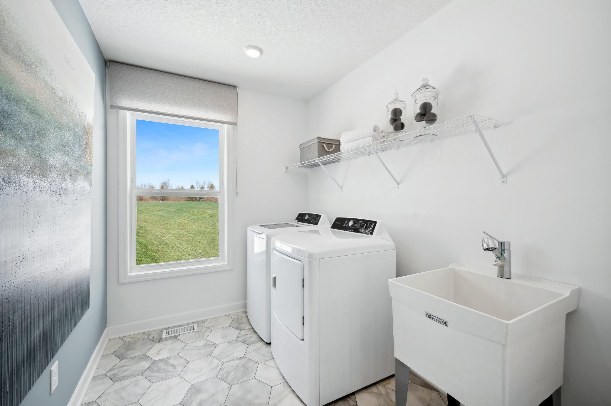 (Photo of a decorated model, actual homes finishes will vary) Upper level laundry! Note: The appliances are not included.