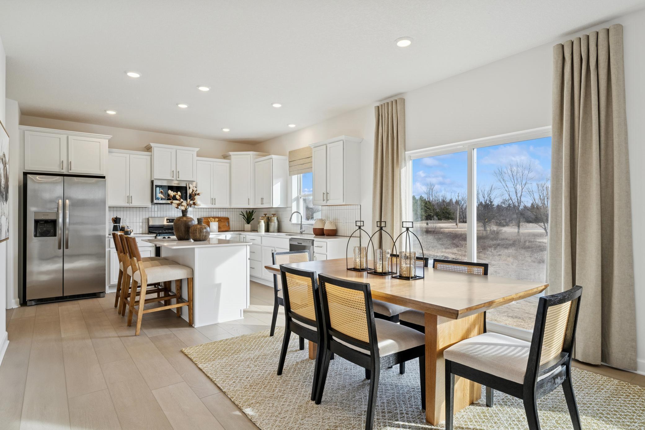 (Photos of model home, finishes will vary) The open-concept design allows for effortless transitions between cooking, eating and relaxing on the couch