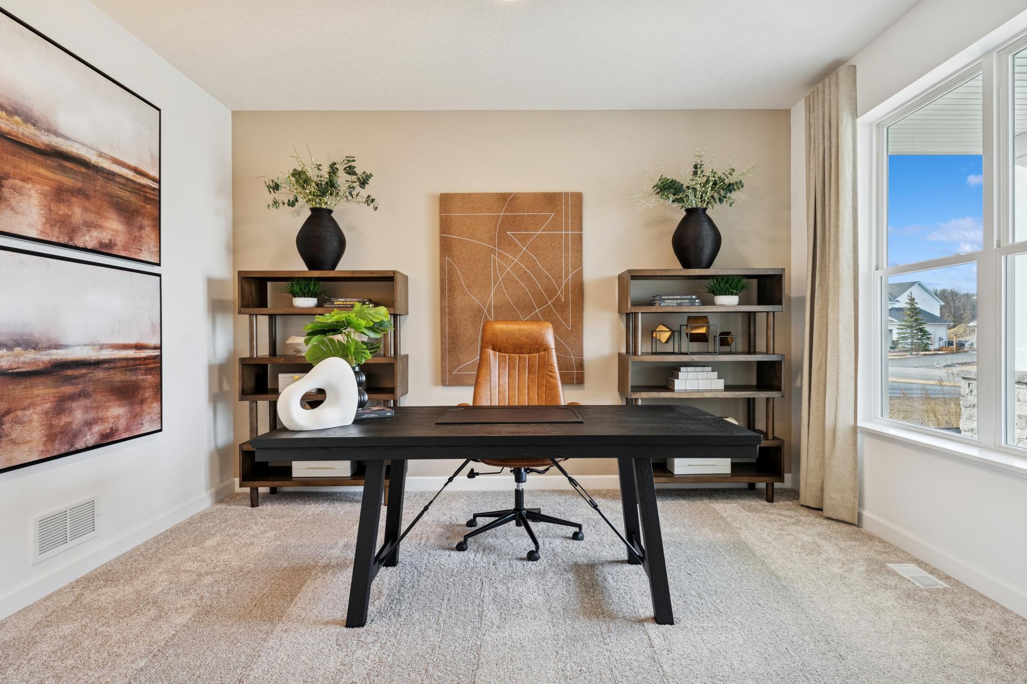 (Photos of model home, finishes will vary) A versatile flex space situated off the foyer is ideal for a home office, as shown here.