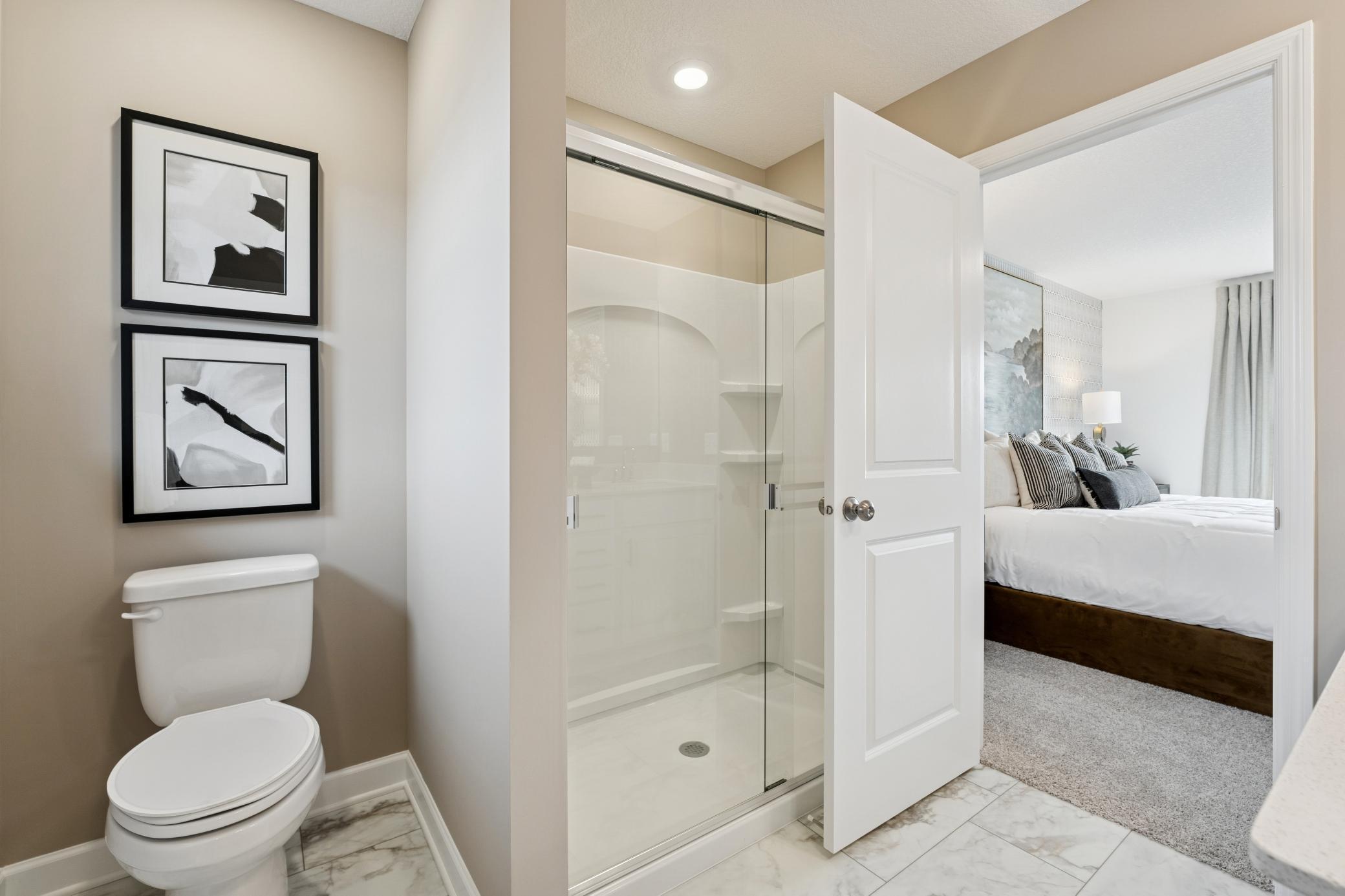 (Photos of model home, finishes will vary) Along with a sophisticated glass-enclosed shower, the en-suite bathroom features convenient access to the walk-in closet