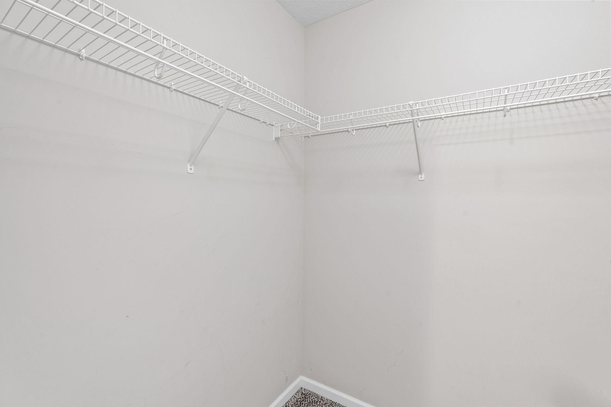 Plenty of organized storage can be found throughout the upper level with wrap-around wire shelving in each closet nook.