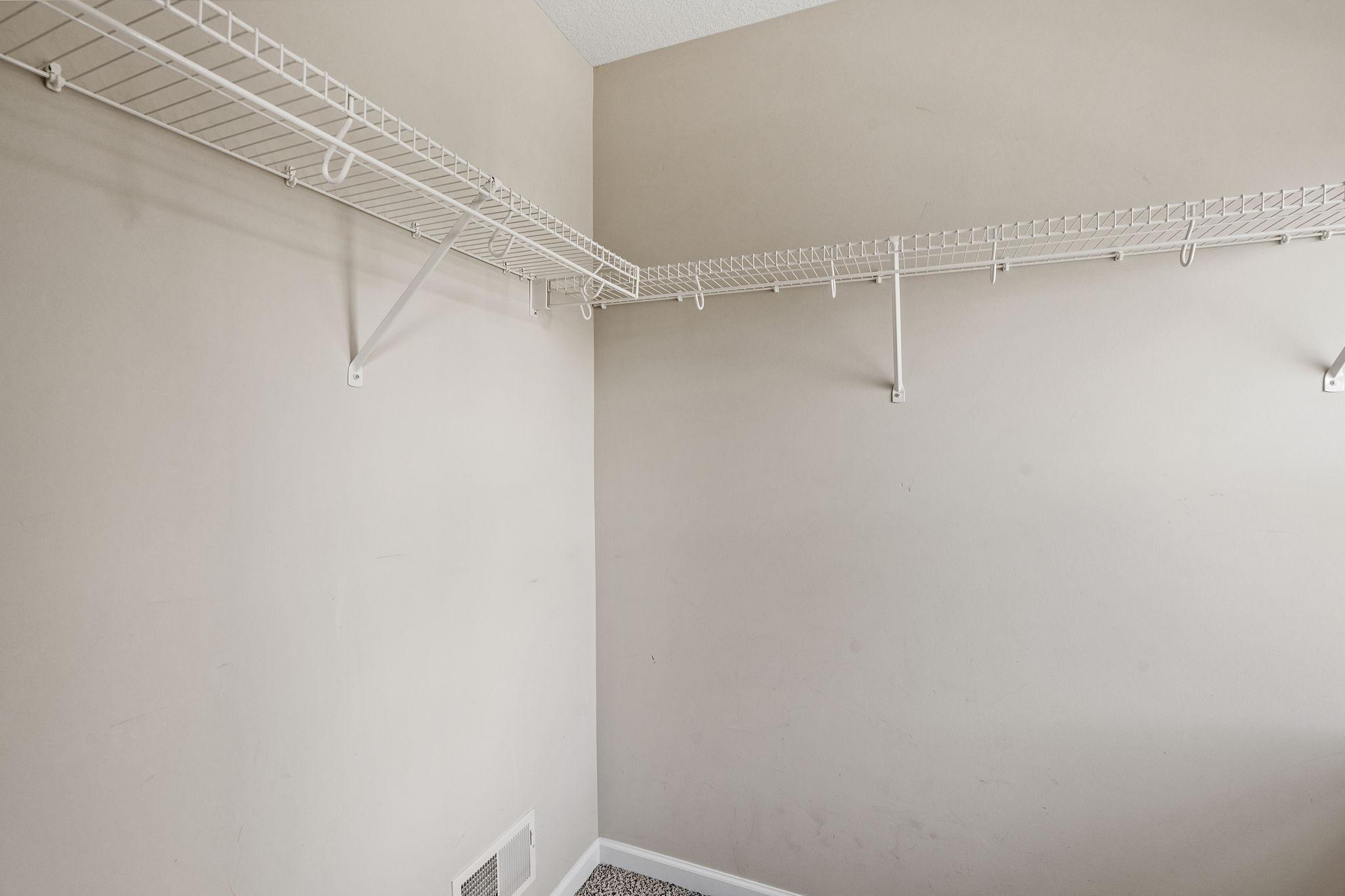 Secondary bedrooms offer exceptional storage with deep walk-in closets outfitted with wrap-around shelving.