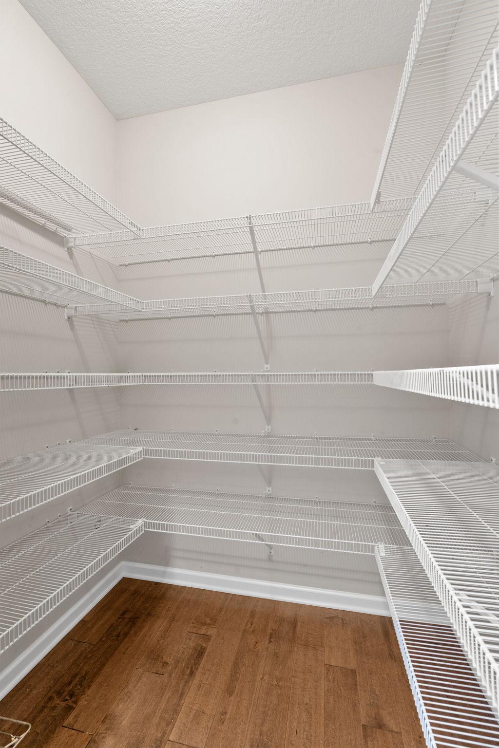 Keep organized with this massive walk-in kitchen pantry, fully outfitted with wrap-around wire shelving and plenty of floor-to-ceiling storage.