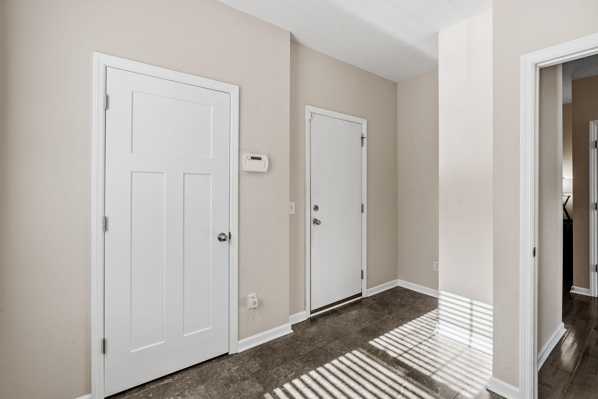 A highly functional rear entry zone right off the garage offering durable tile flooring and access to main-level storage.