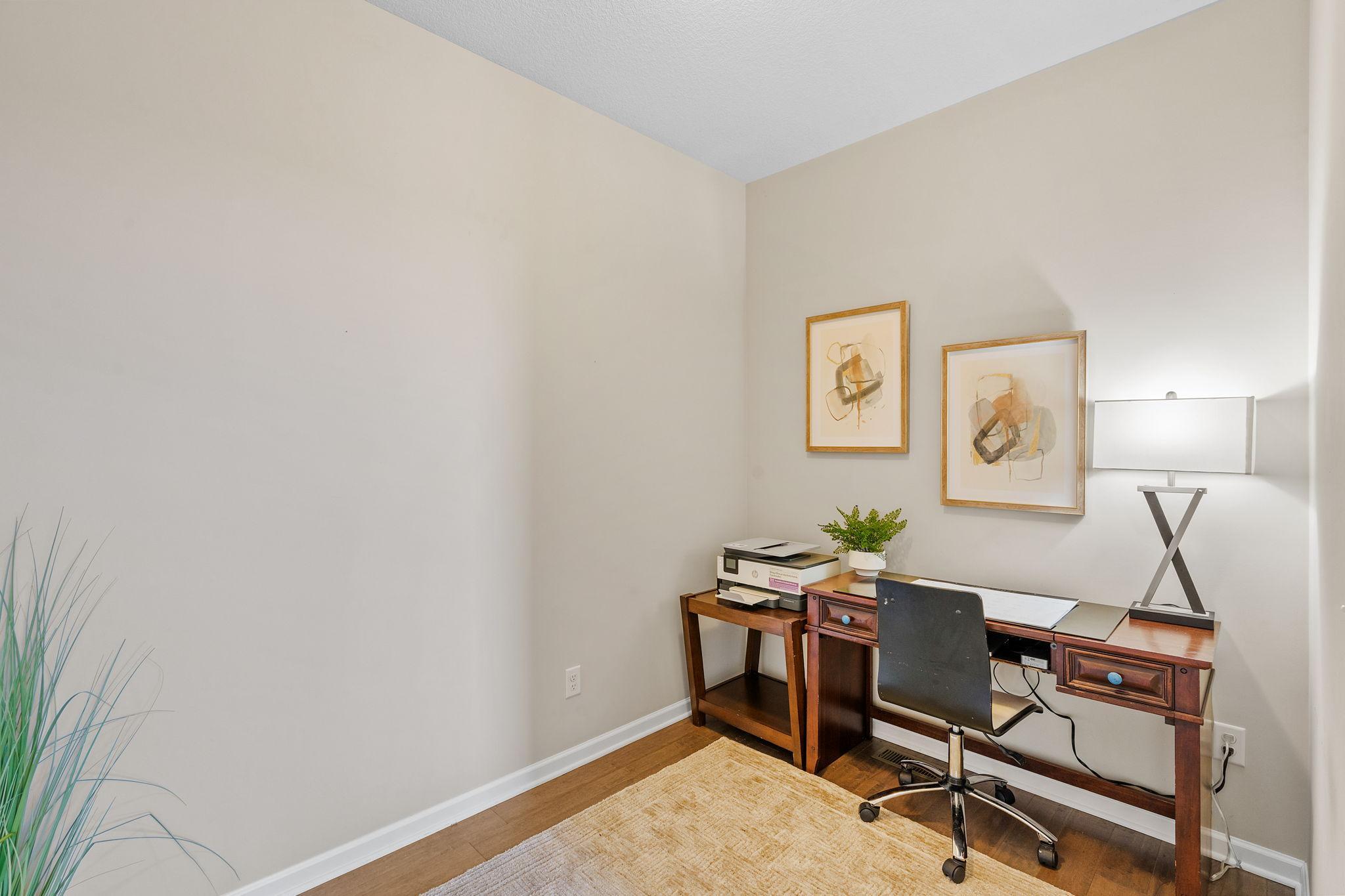 Tuck away your tech in this quiet, separate home office corner, finished with warm hardwood flooring and neutral paint tones.