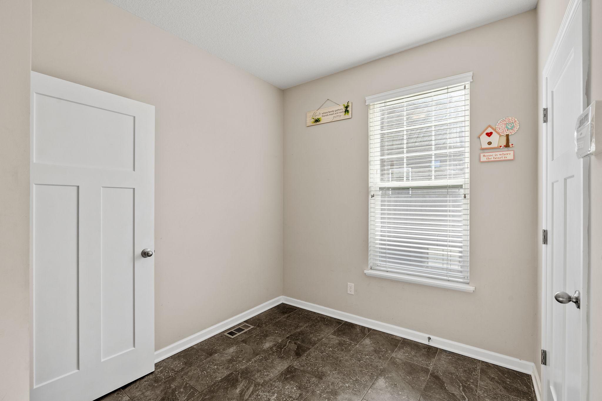 Tucked quietly away, this multi-purpose space features a large window and is ideal for a hobby room, secondary office, or play area.