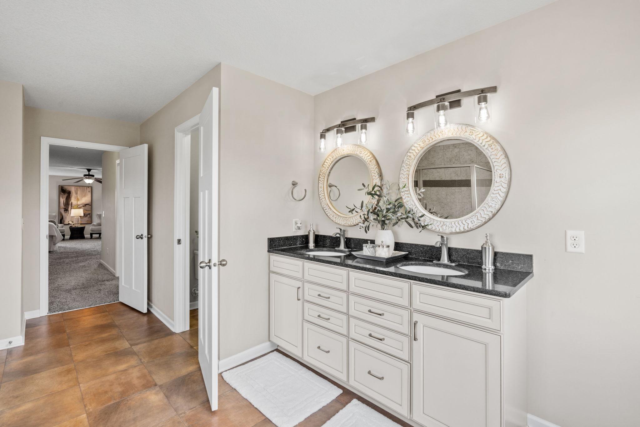 This view showcases the smooth transition from the tiled ensuite bathroom straight into the spacious primary bedroom retreat.