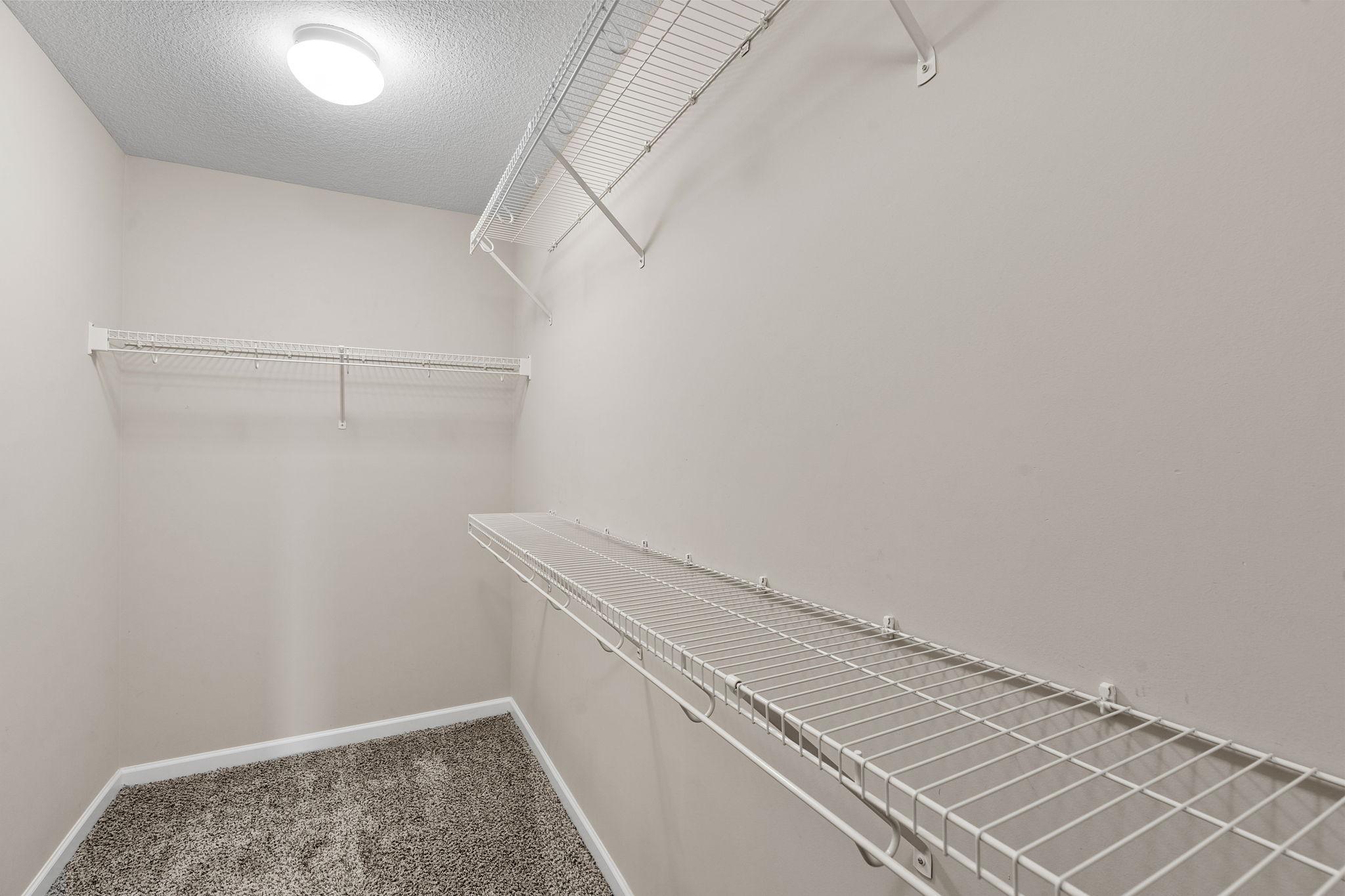 The matching secondary walk-in closet ensuring independent storage space and organization for the homeowners.