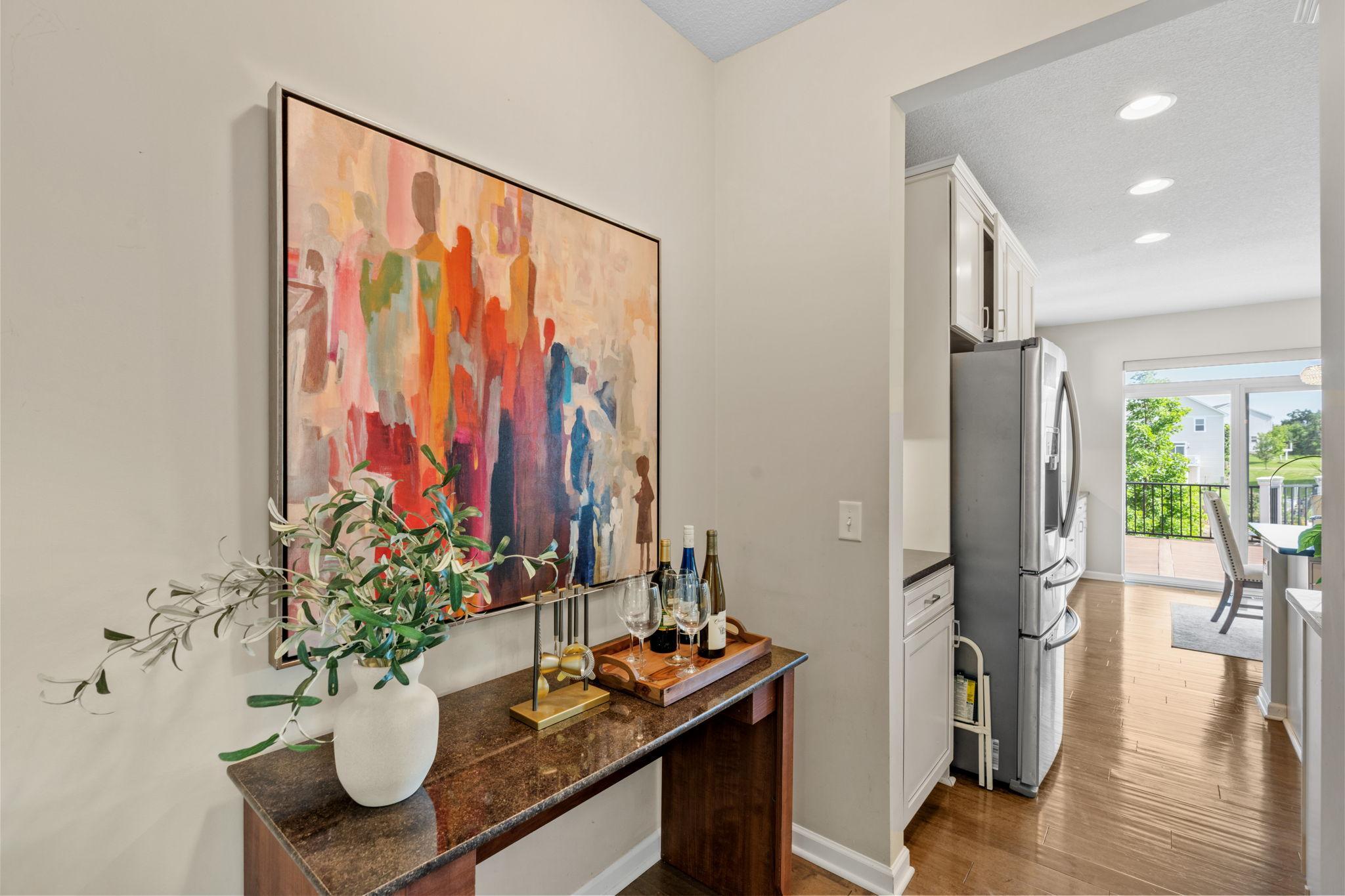 Tucked conveniently between the dining area and kitchen is a built-in granite-topped staging area, perfect for a coffee station or wine bar.