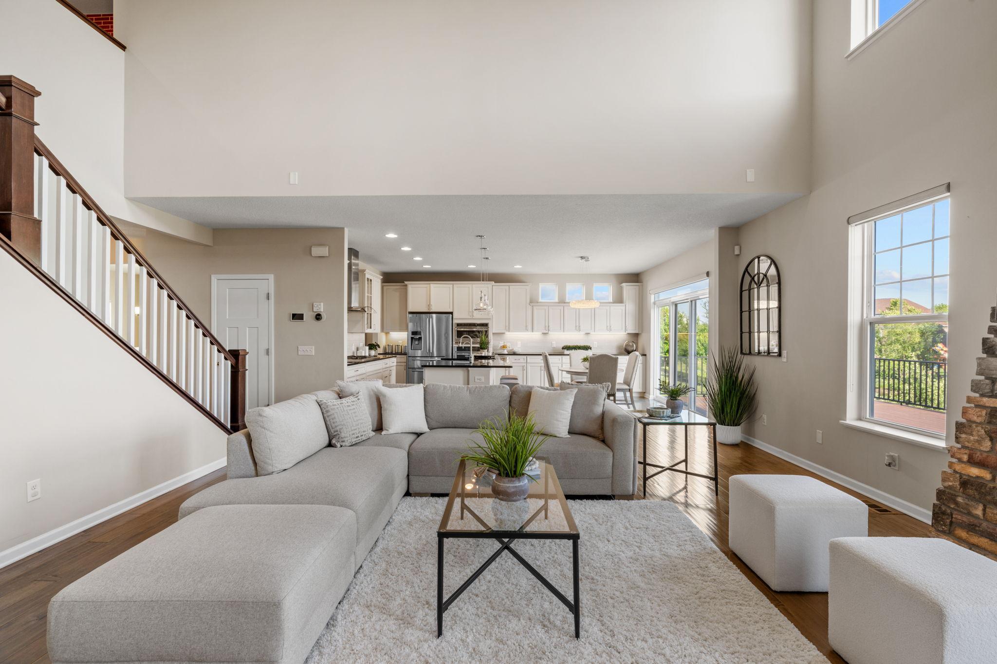 The wide-open main floor configuration ensures that anyone in the spacious living room stays fully connected to the kitchen and dining hub.