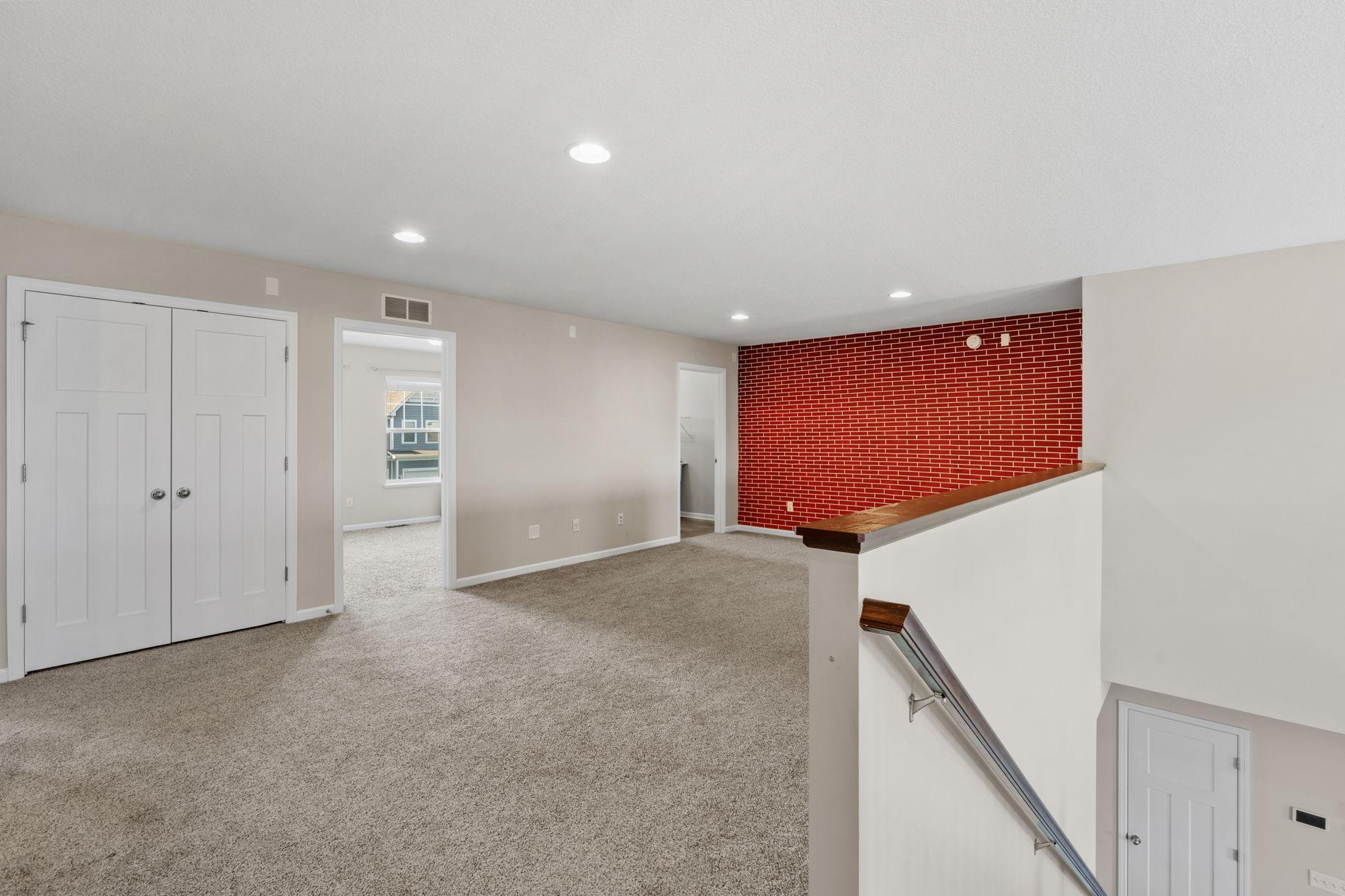 View from the stairs highlights the impressive scale of the loft, boasting open views of the lower level and easy flow to upper bedrooms.