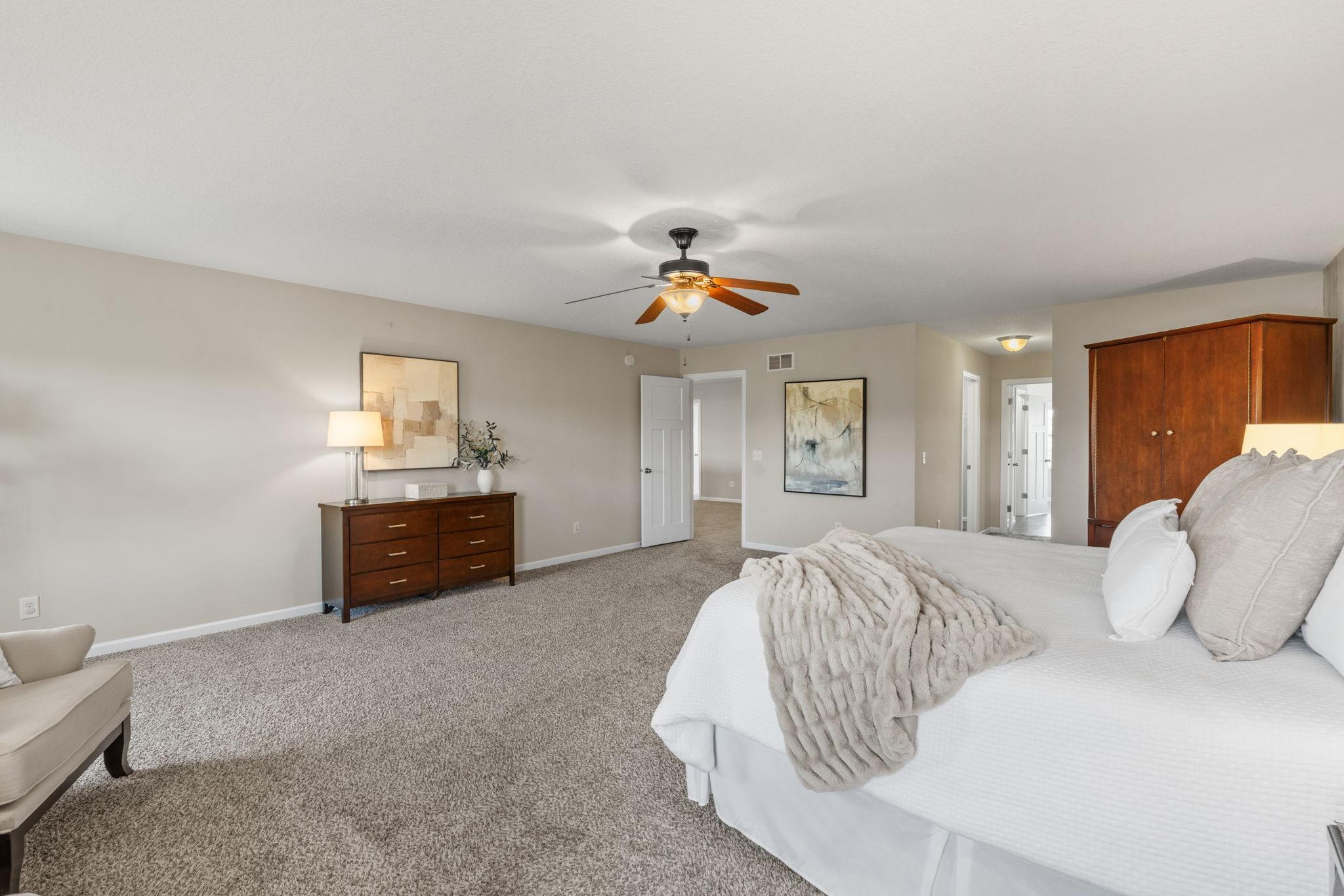 Generous room proportions provide endless space for a king-sized bed, additional dressers, a wardrobe armoire, and comfortable accent seating.
